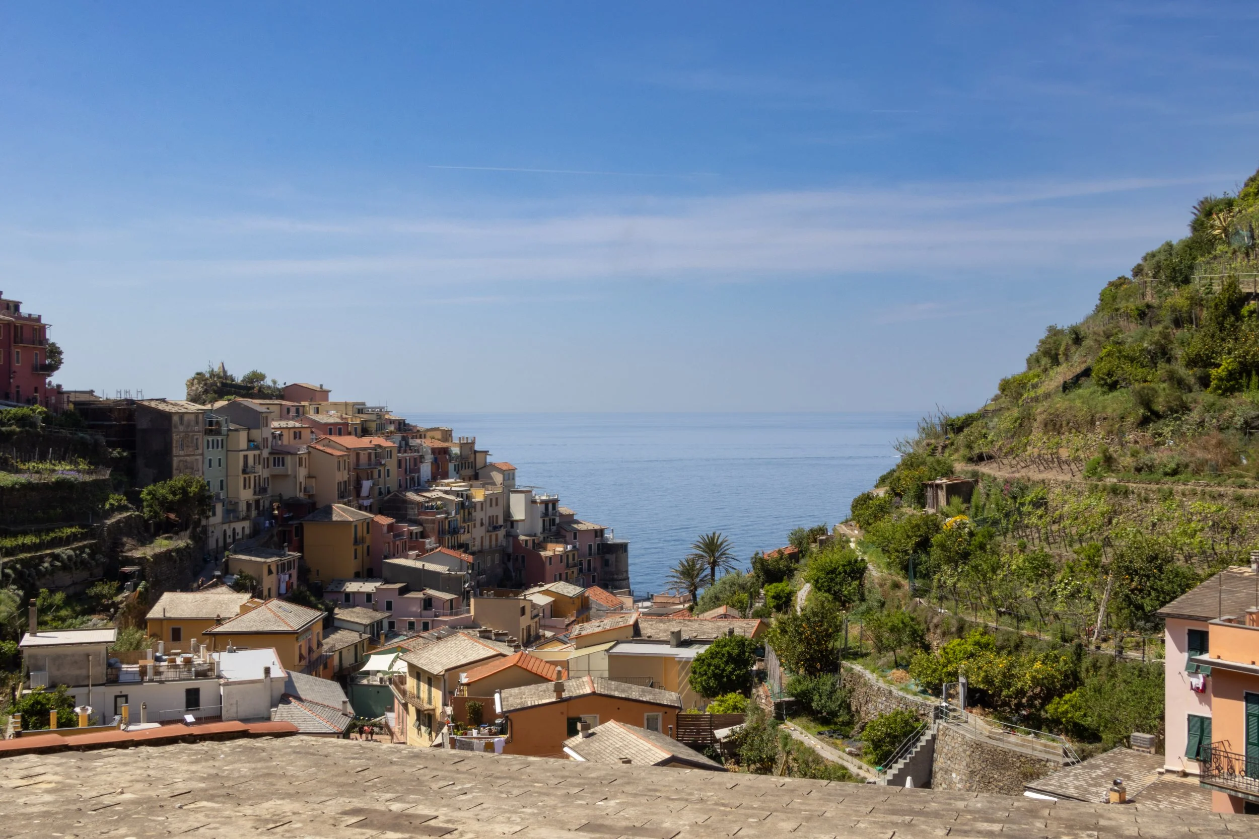 Cinque Terre, Italy | A hillside village surrounded by the coastal landscape of Cinque Terre.