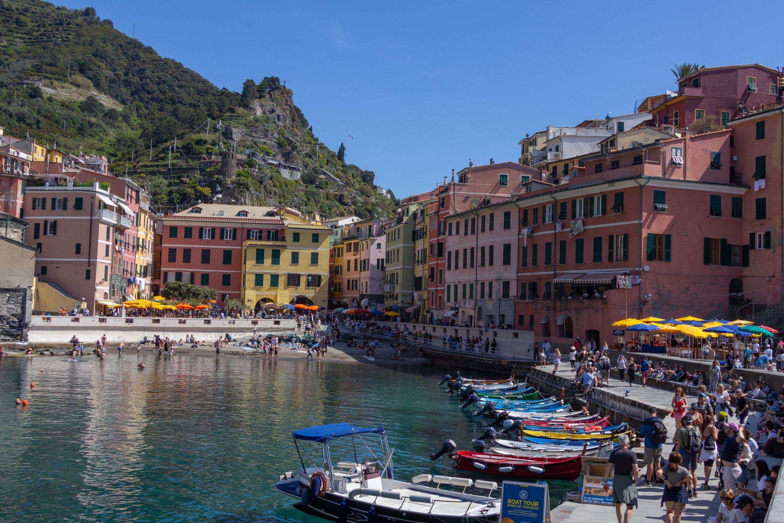 Cinque Terre, Italy | Colorful buildings and boats line the waterfront of Cinque Terre. 