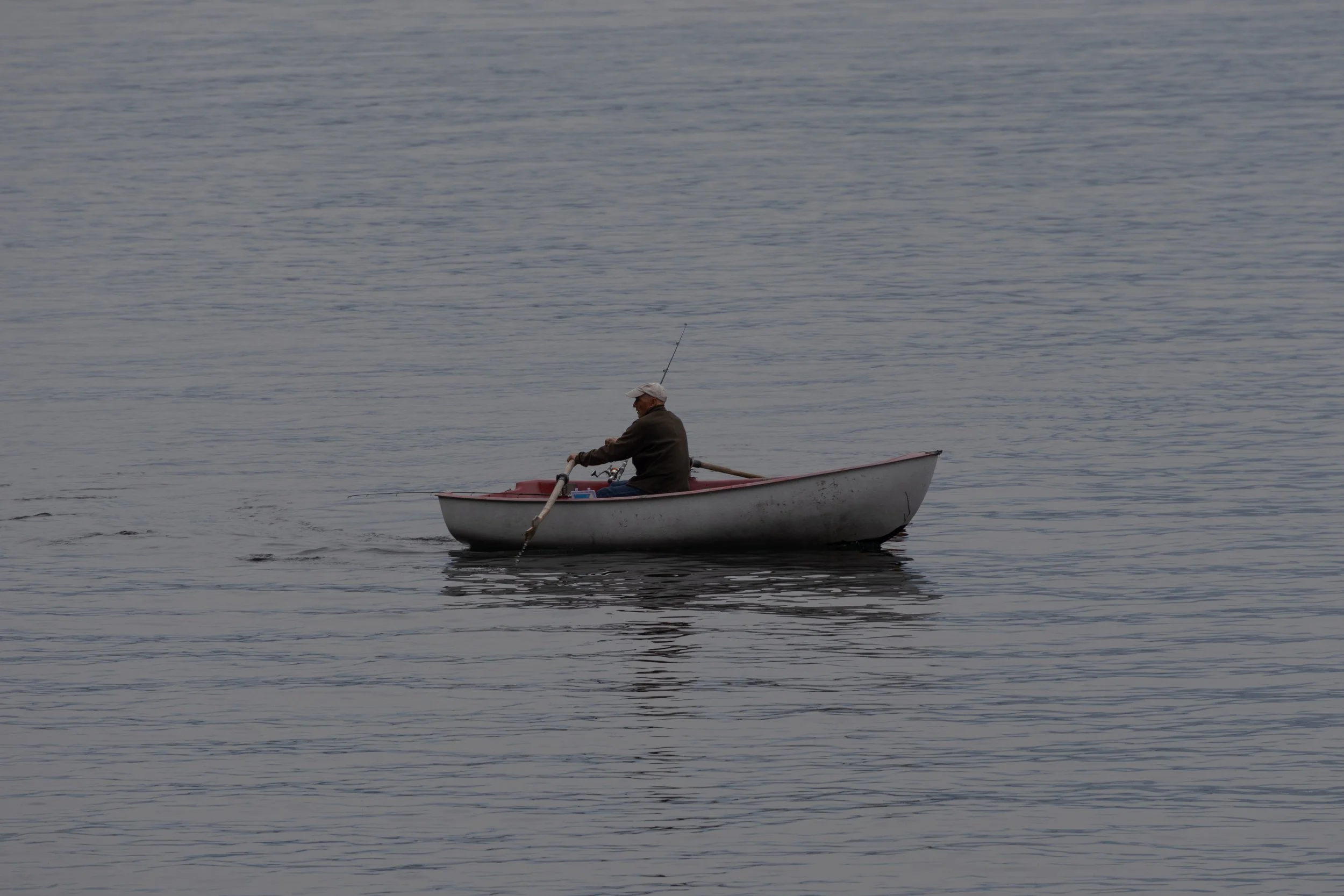 Bellagio, Italy | A lone fisherman drifts across the calm waters of Lake Como near Bellagio. 