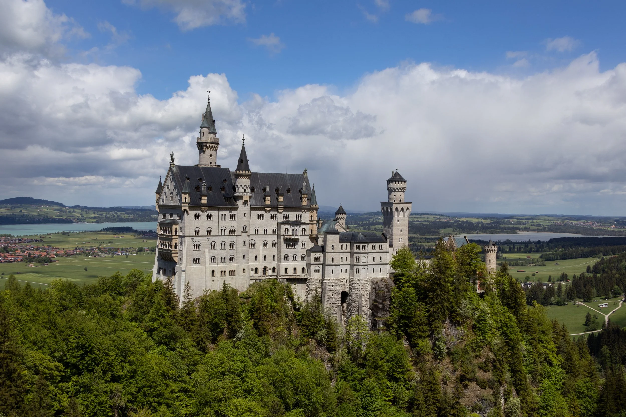 Bavaria, Germany | Neuschwanstein Castle rises above the forests of the Bavarian alps. 