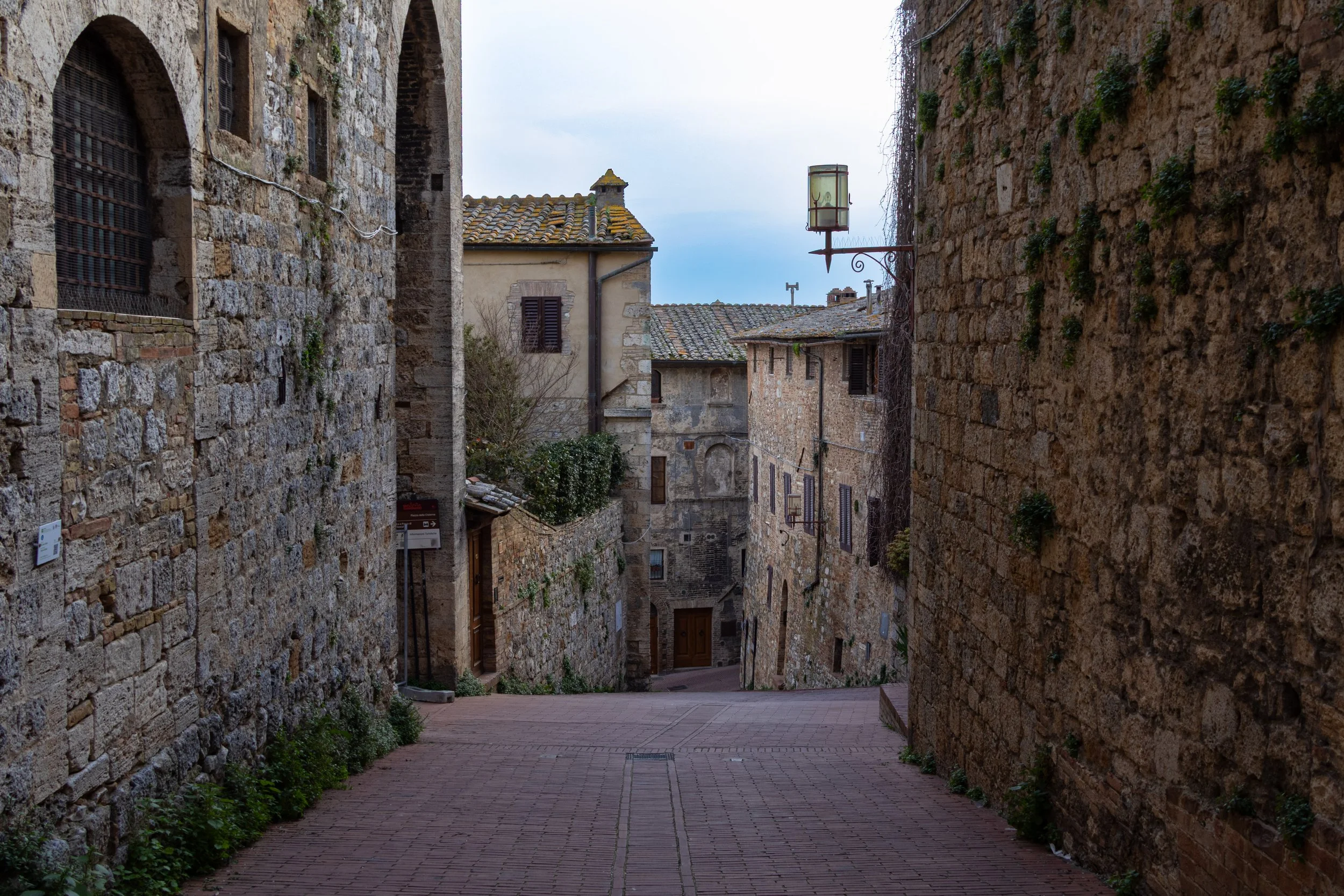 San Gimignano, Italy | A quiet stone street in San Gimignano, where centuries of history are preserved in every alleyway and weathered wall. 