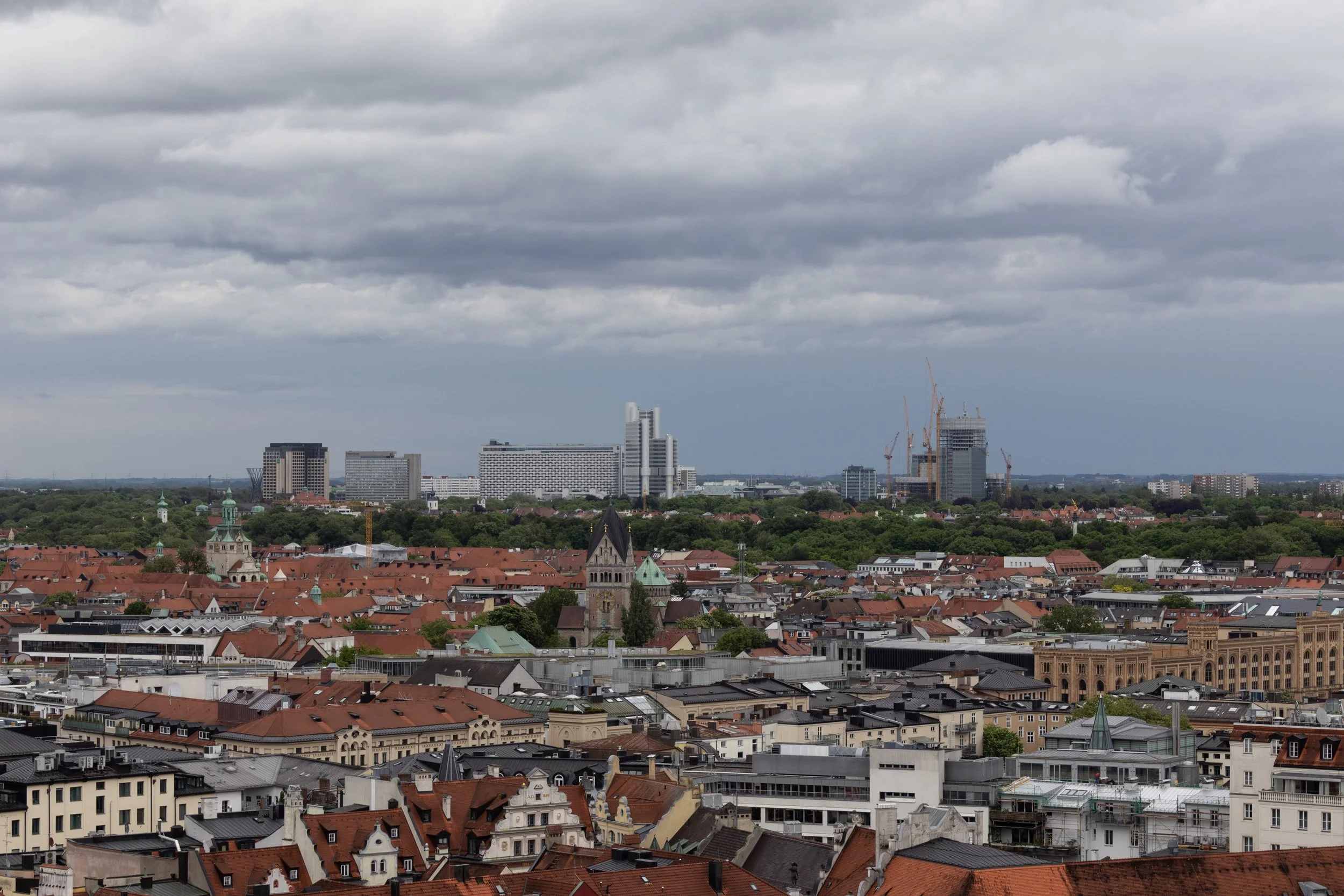 Munich, Germany | Storm clouds gather over Munich, creating a dramatic view of the city's rooftops and skyline. 