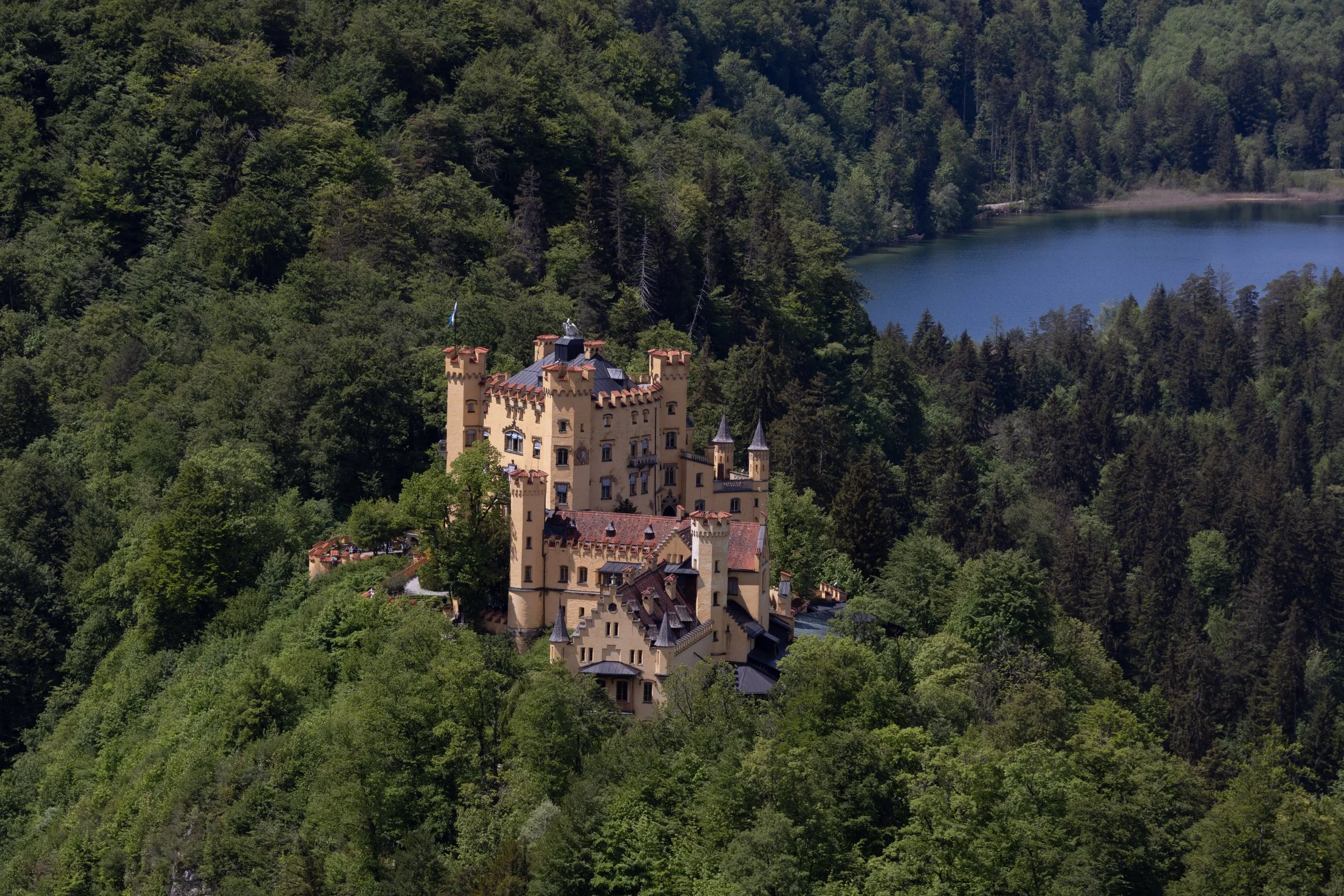 Bavaria, Germany | Hohenschwangau Castle sits among the forests overlooking Alpsee.  