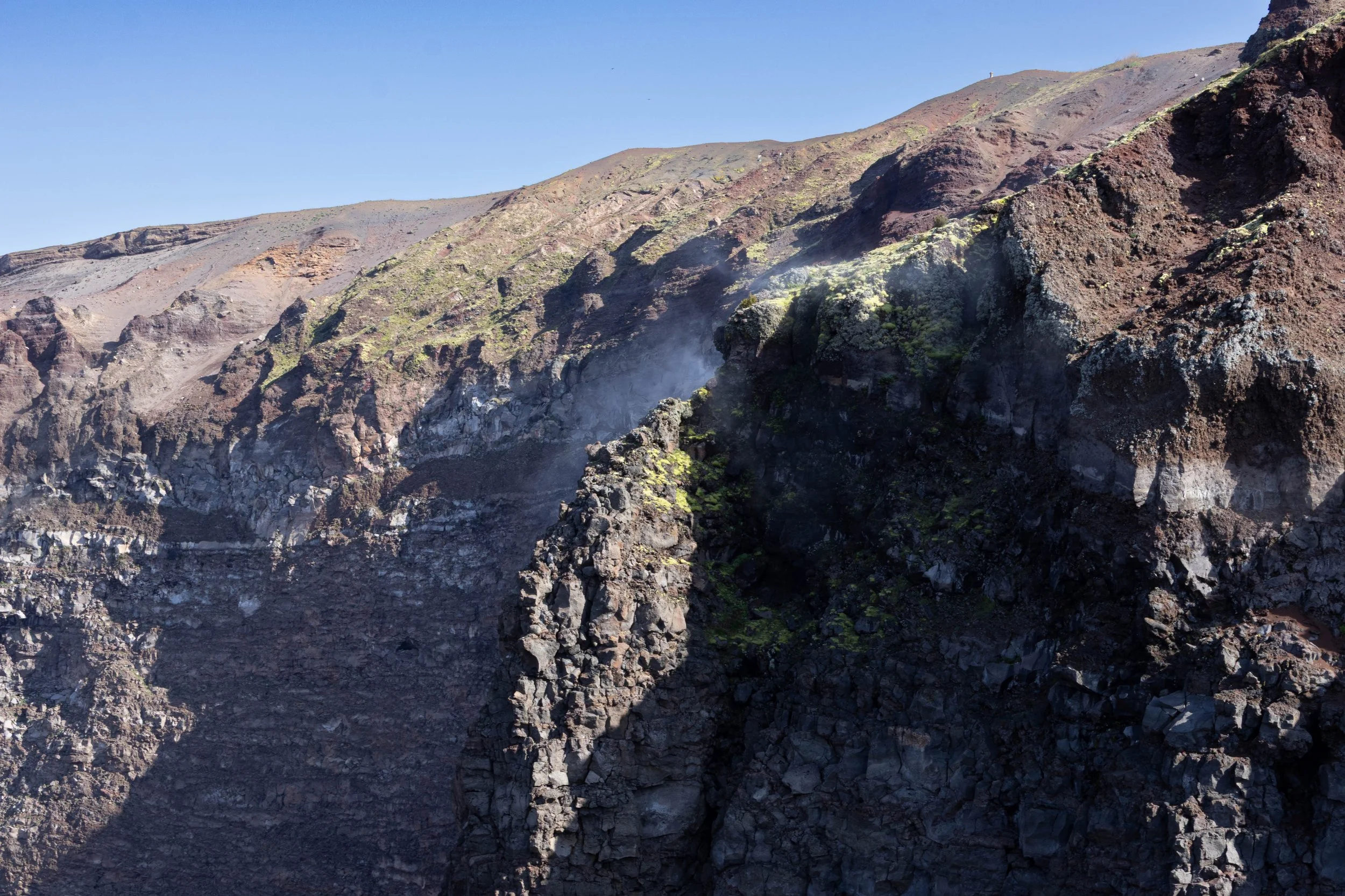 Naples, Italy | A closer view of the steaming volcanic rock formations inside the crater of Mount Vesuvius. 