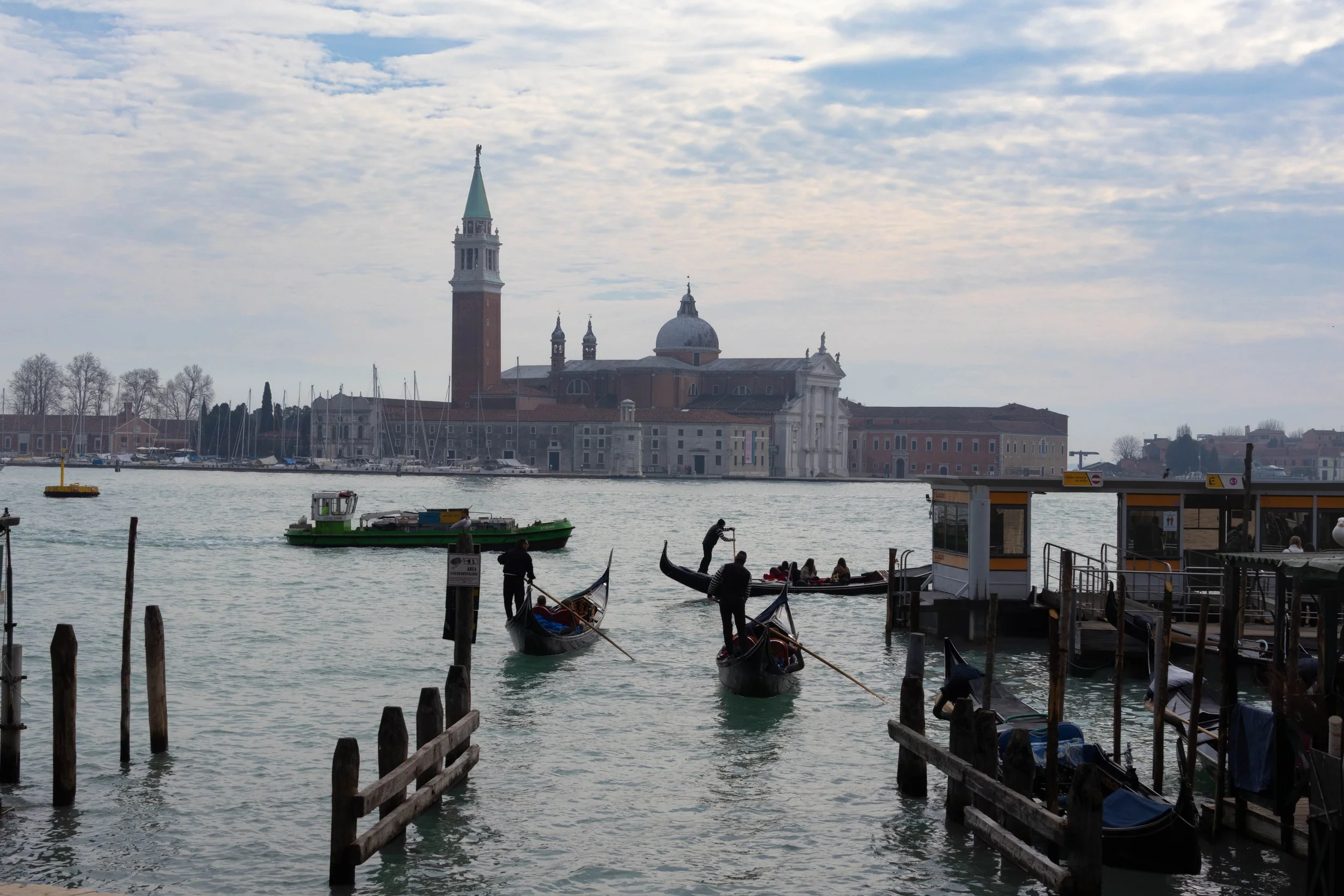 Venice, Italy | Gondolas cross the Venetian Lagoon with San Giorgio Maggiore in the background. 