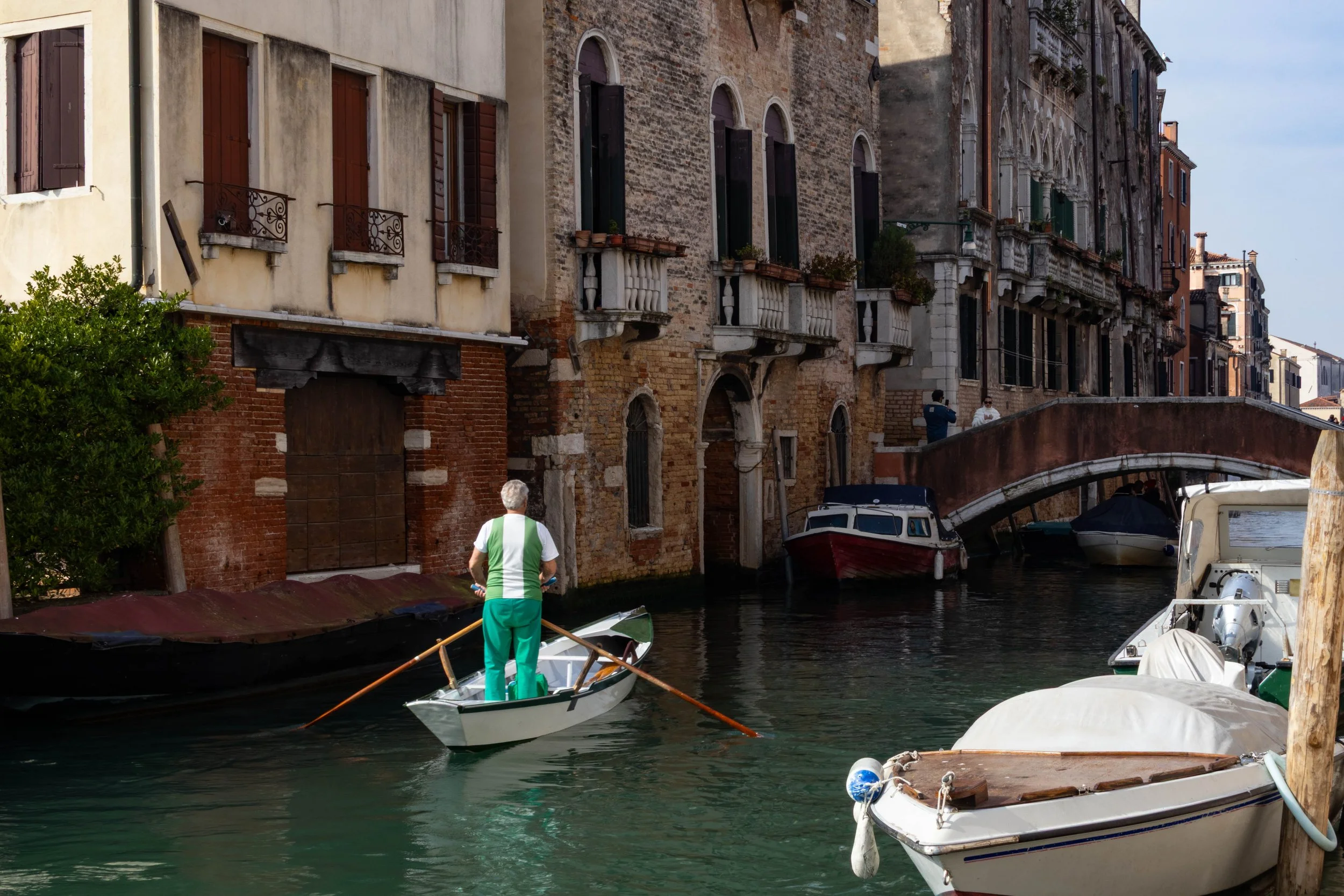 Venice, Italy | A local boater rows through a quiet canal in Venice. 