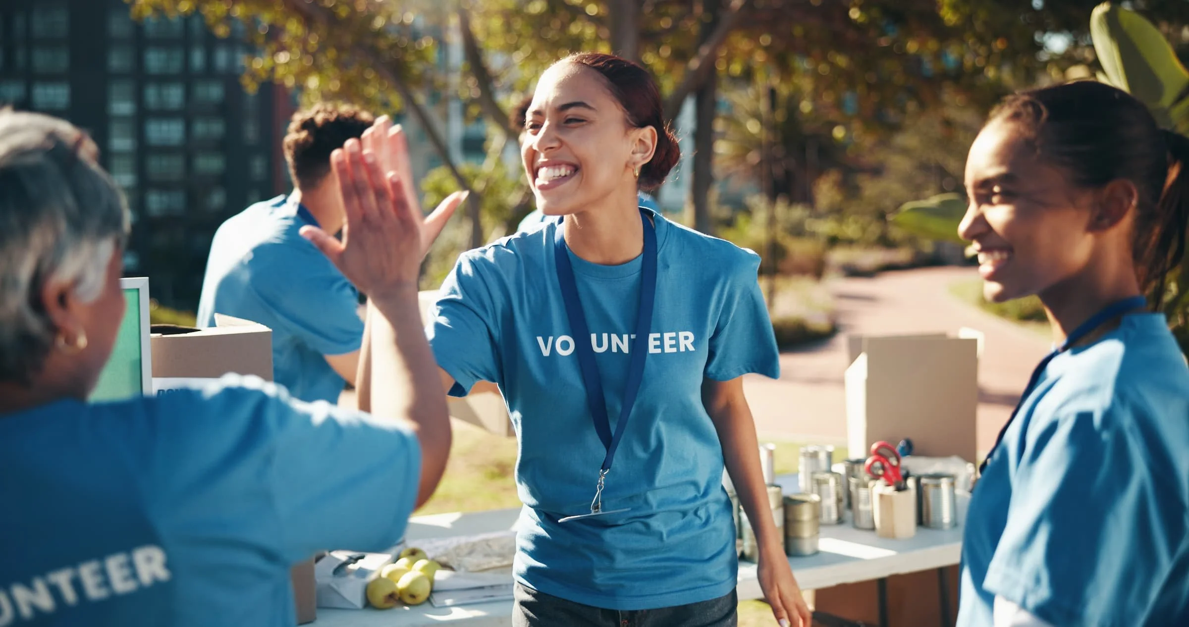 Group of volunteers smiling and high fiving.
