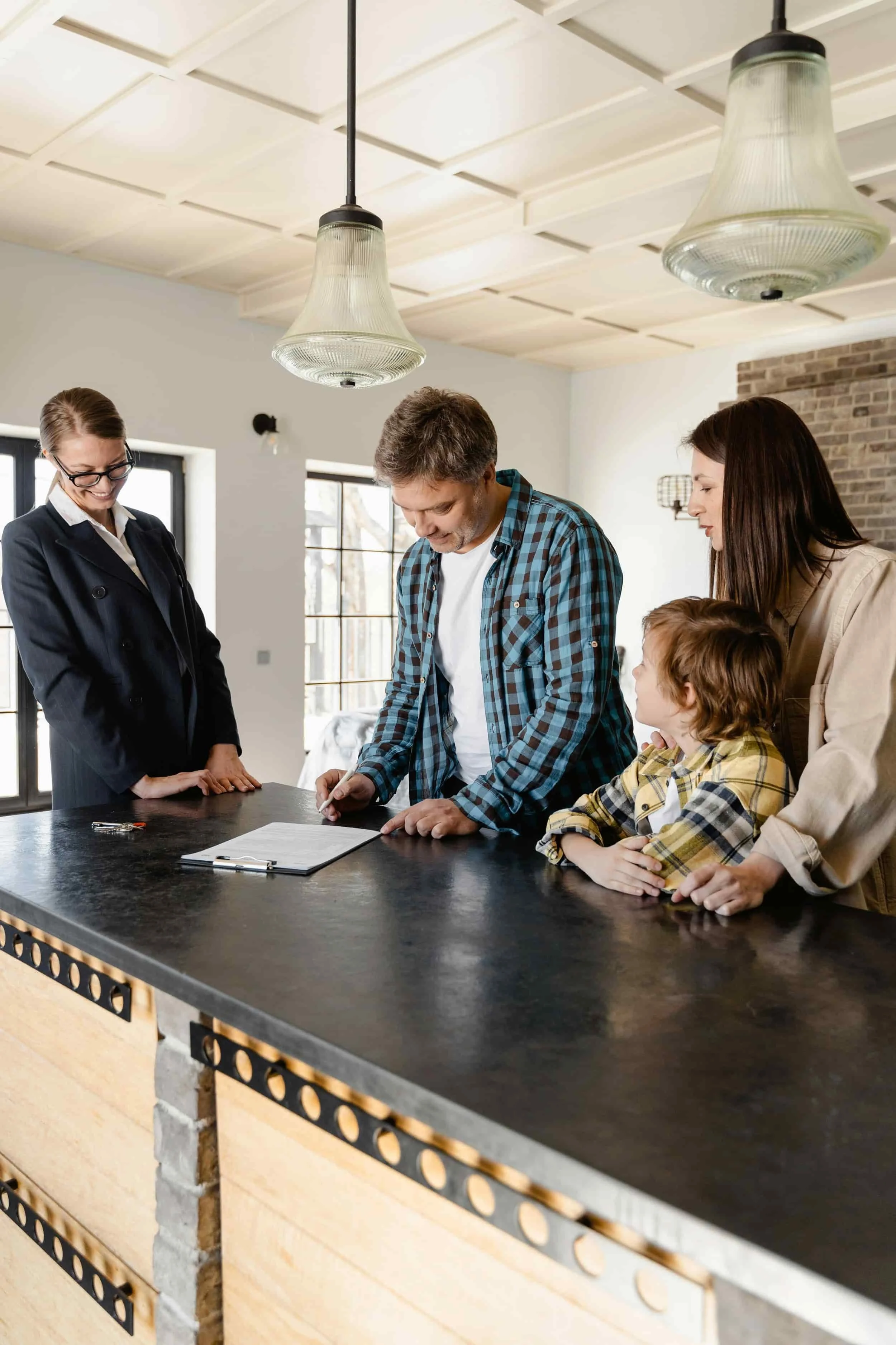A family closing a deal by signing off on the paperwork.