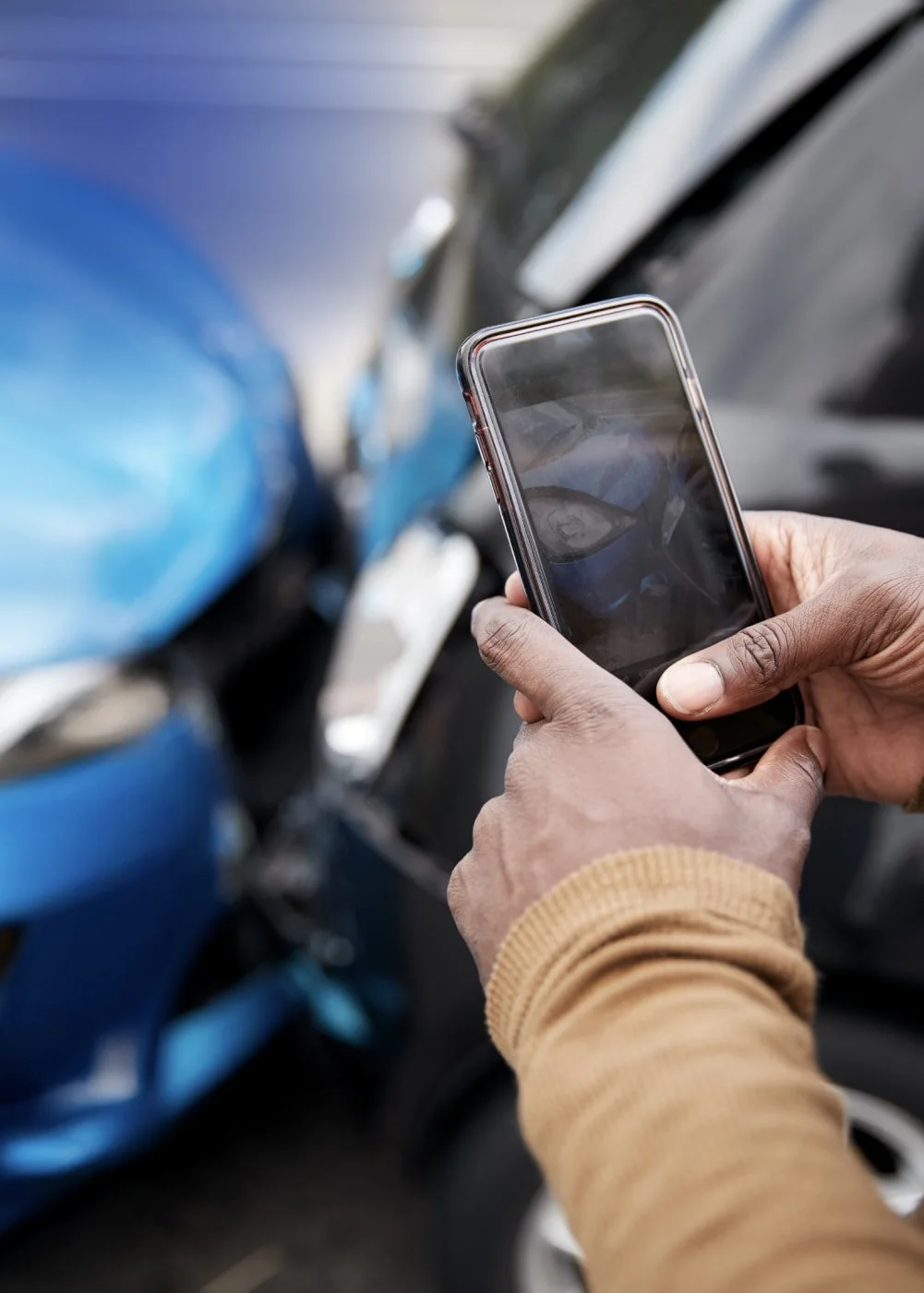 Vehicle Protection Services: Person taking picture of car accident with iPhone.