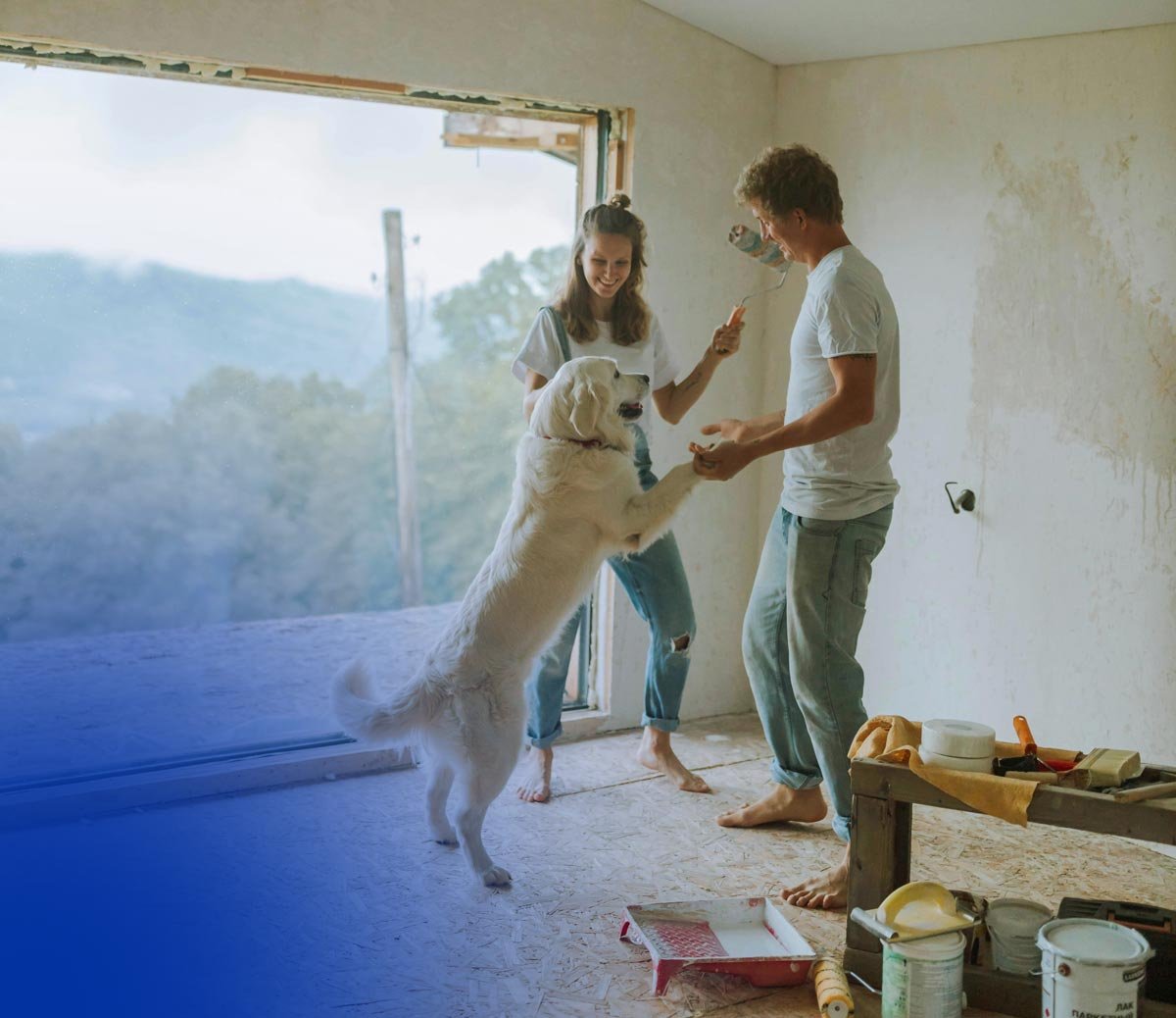 Couple dancing with dog while making improvements on their home.
