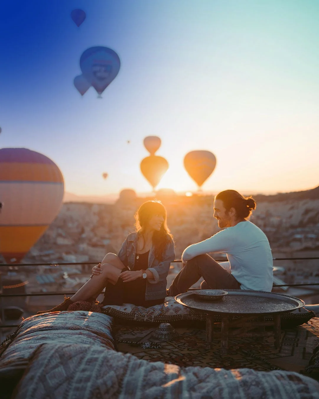 Couple viewing hot air balloon festival.
