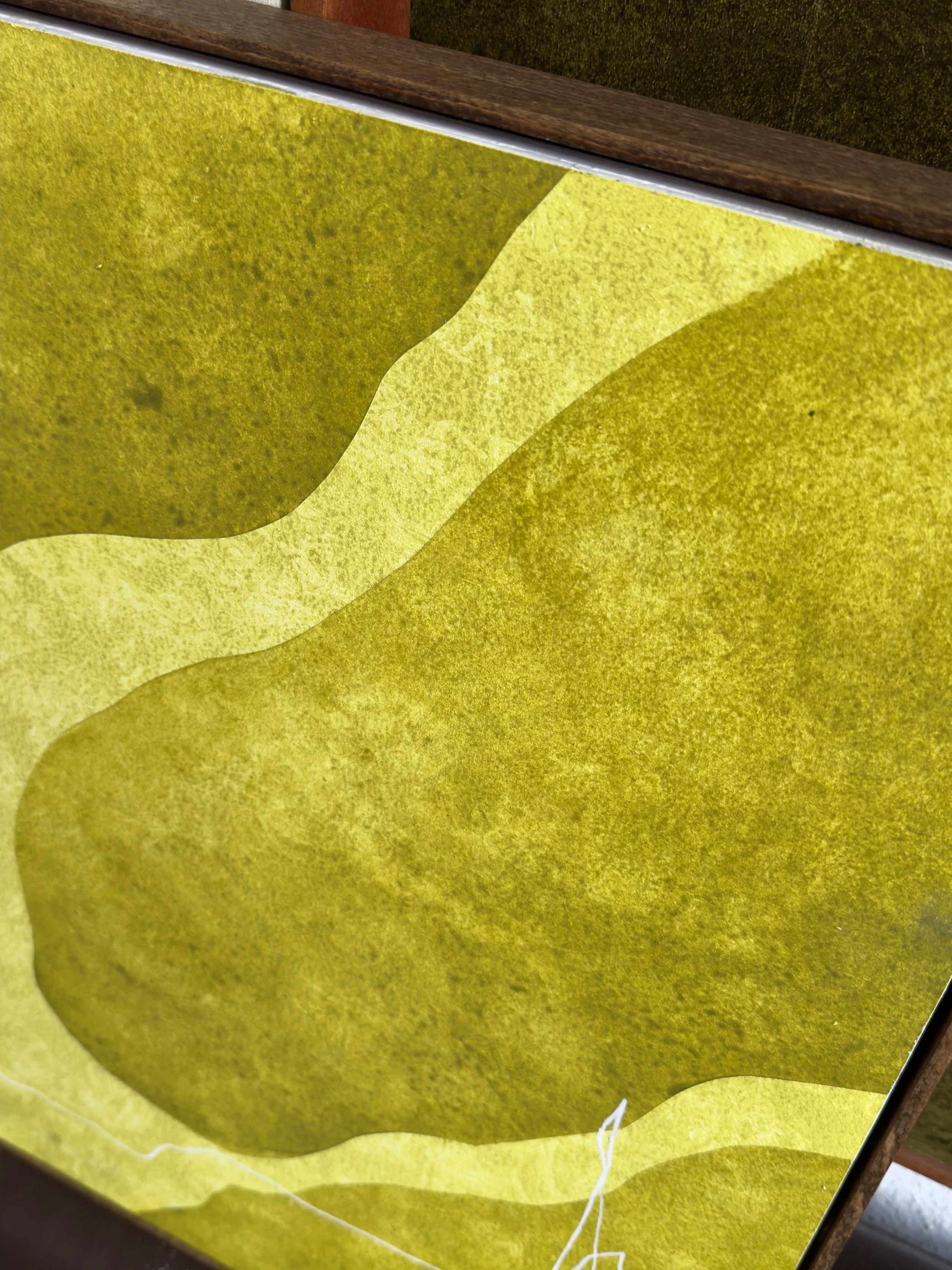 Abstrakte Kunst mit Gelb- und Grüntönen auf einer rechteckigen Oberfläche, möglicherweise ein Gemälde oder eine Druckarbeit.