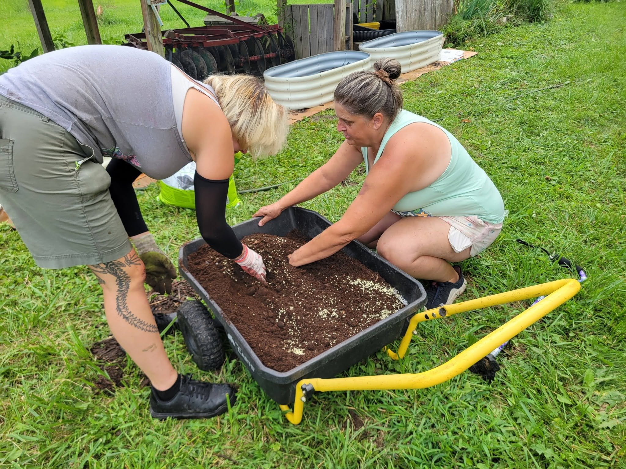 Bloom & Weed gardeners mixing soil for raised beds in Stockbridge, MI
