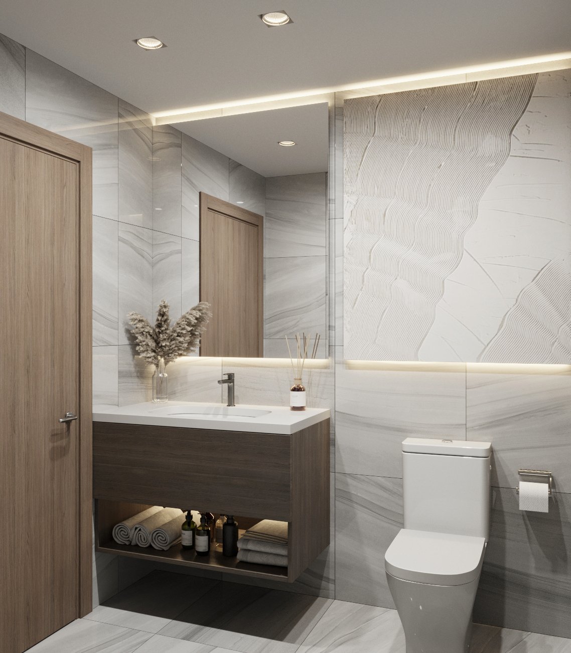 Modern bathroom with a wooden vanity, framed mirror, two closed wooden doors, a vase with pampas grass, a reed diffuser, a white toilet, and white marble walls with a textured decorative panel.
