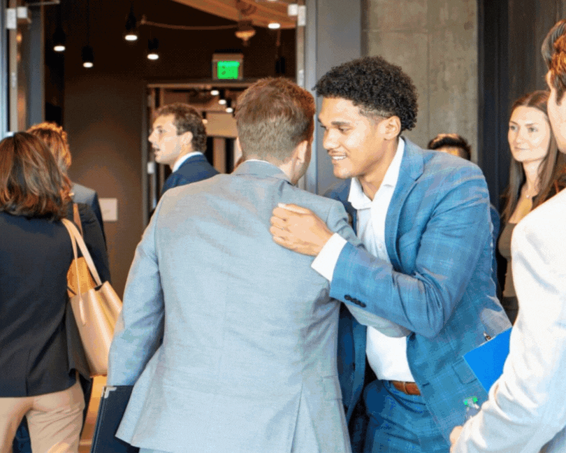 Rotating images of Arlen Hooks with students interested in Commercial Real Estate from various universities during campus visits.