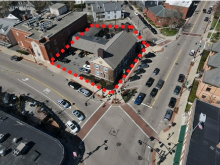 Aerial view of 600 High Street, Dedham bordered by a red dotted line, in an urban area with streets, cars, and sidewalks.