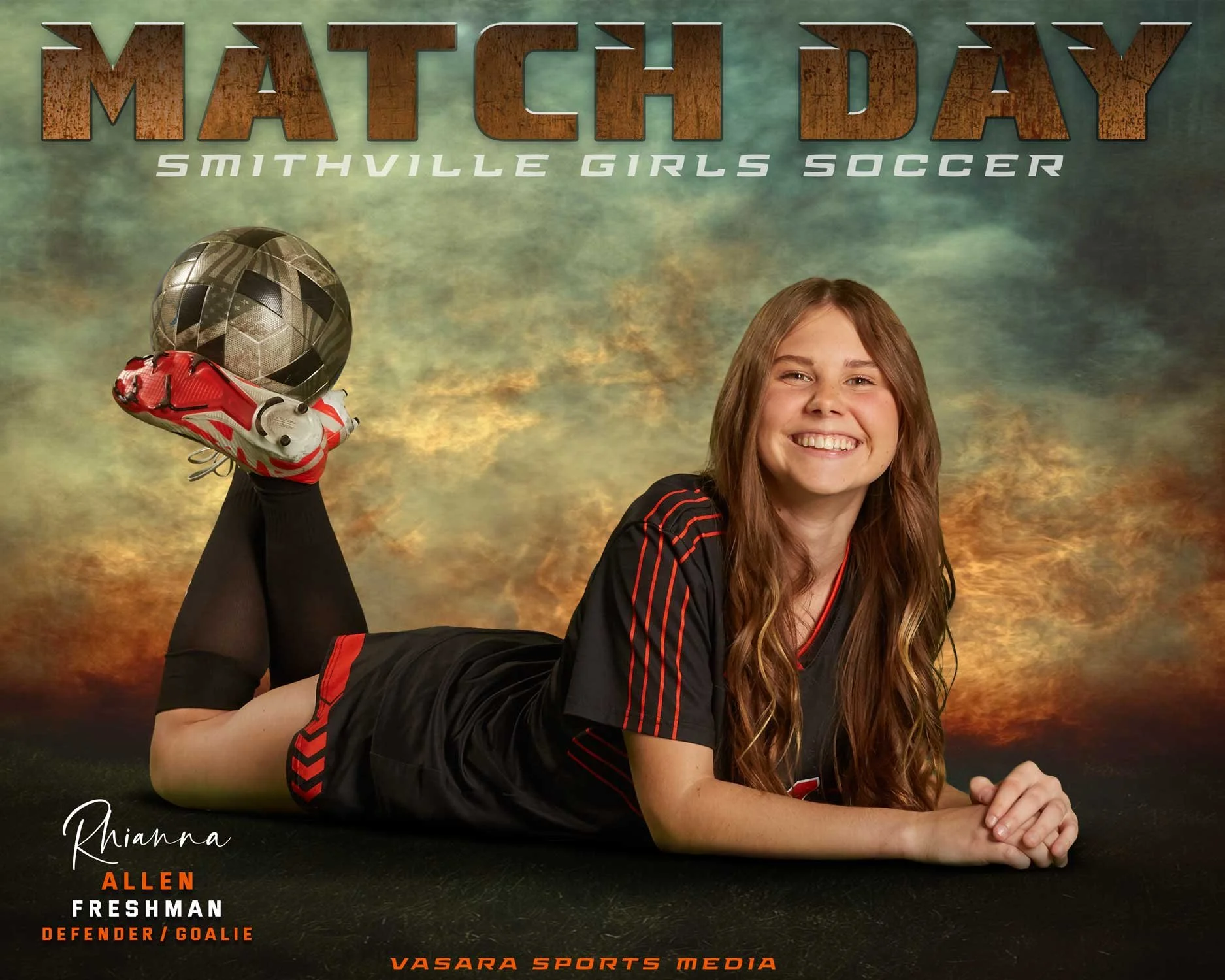 A young girl with long, wavy hair in a soccer uniform lying on her stomach, smiling at the camera, with a soccer ball and cleats balanced on her foot. The background has a dramatic sky with sunset colors. Text indicates she is a defender/goalie named Rhianna Allen, part of Smithville Girls Soccer team, with the photo credited to Vasara Sports Media.