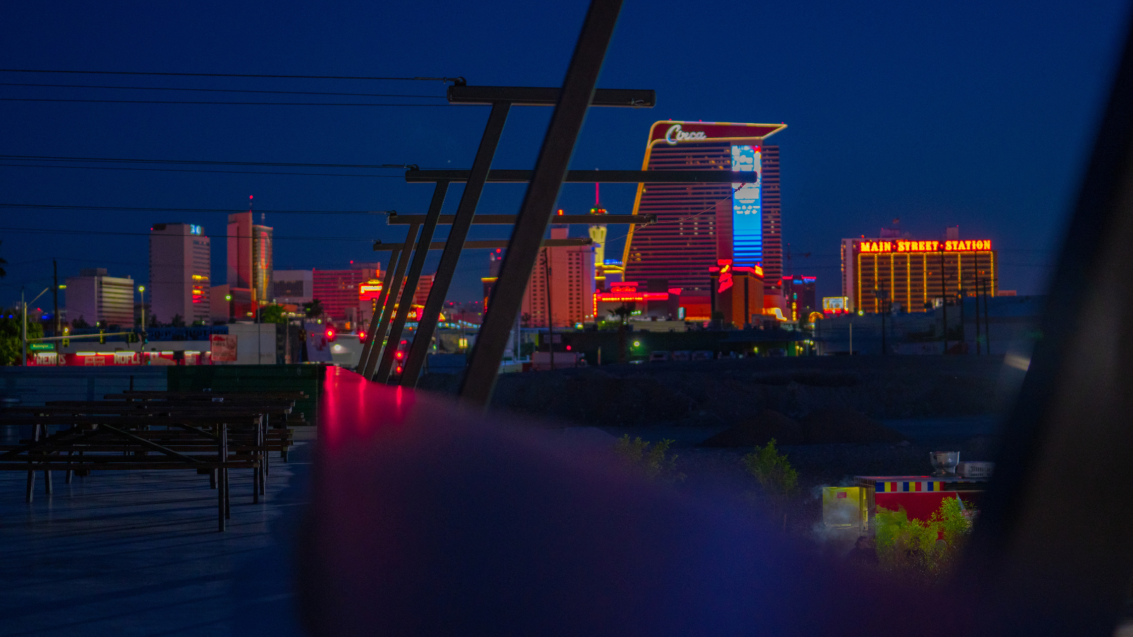Downtown Las Vegas skyline at night viewed from the Sky High Lounge outdoor courtyard.