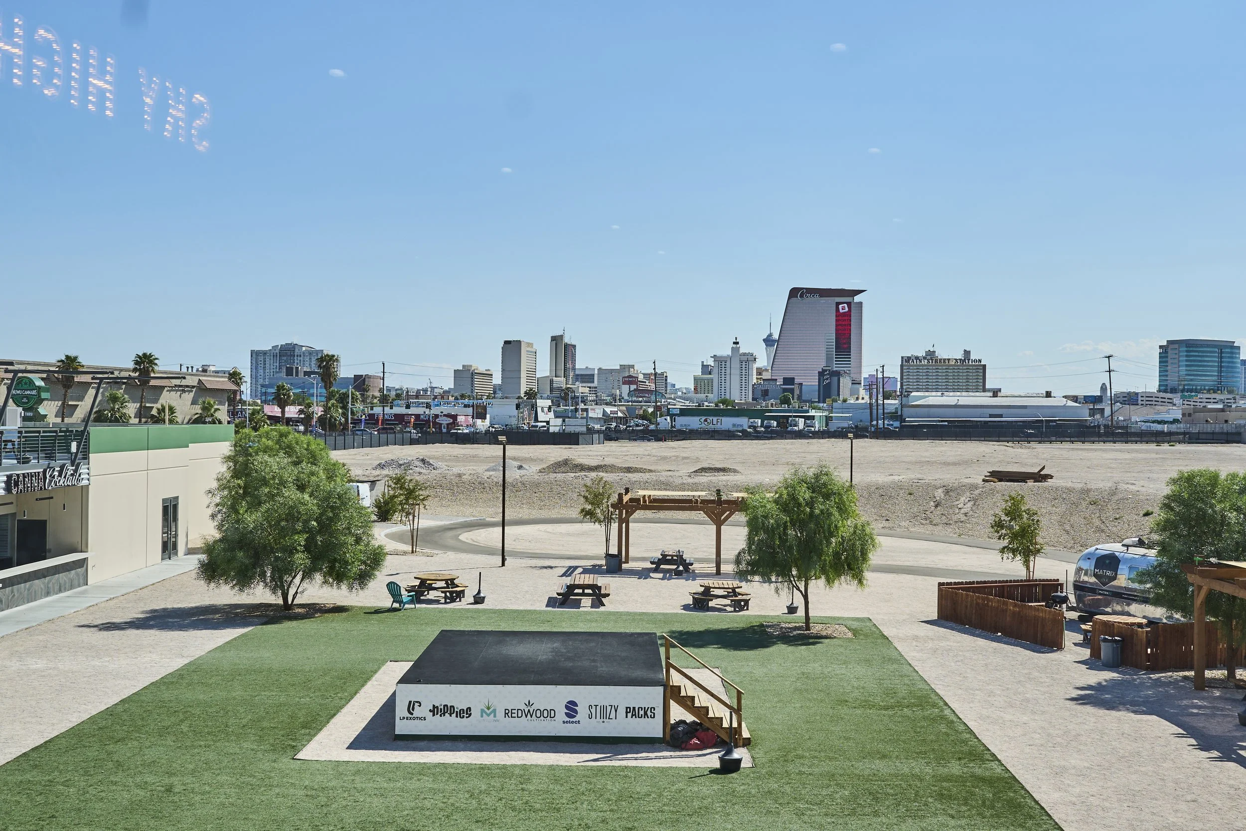 Sky High Lounge outdoor courtyard with seating and stage, overlooking the downtown Las Vegas skyline.