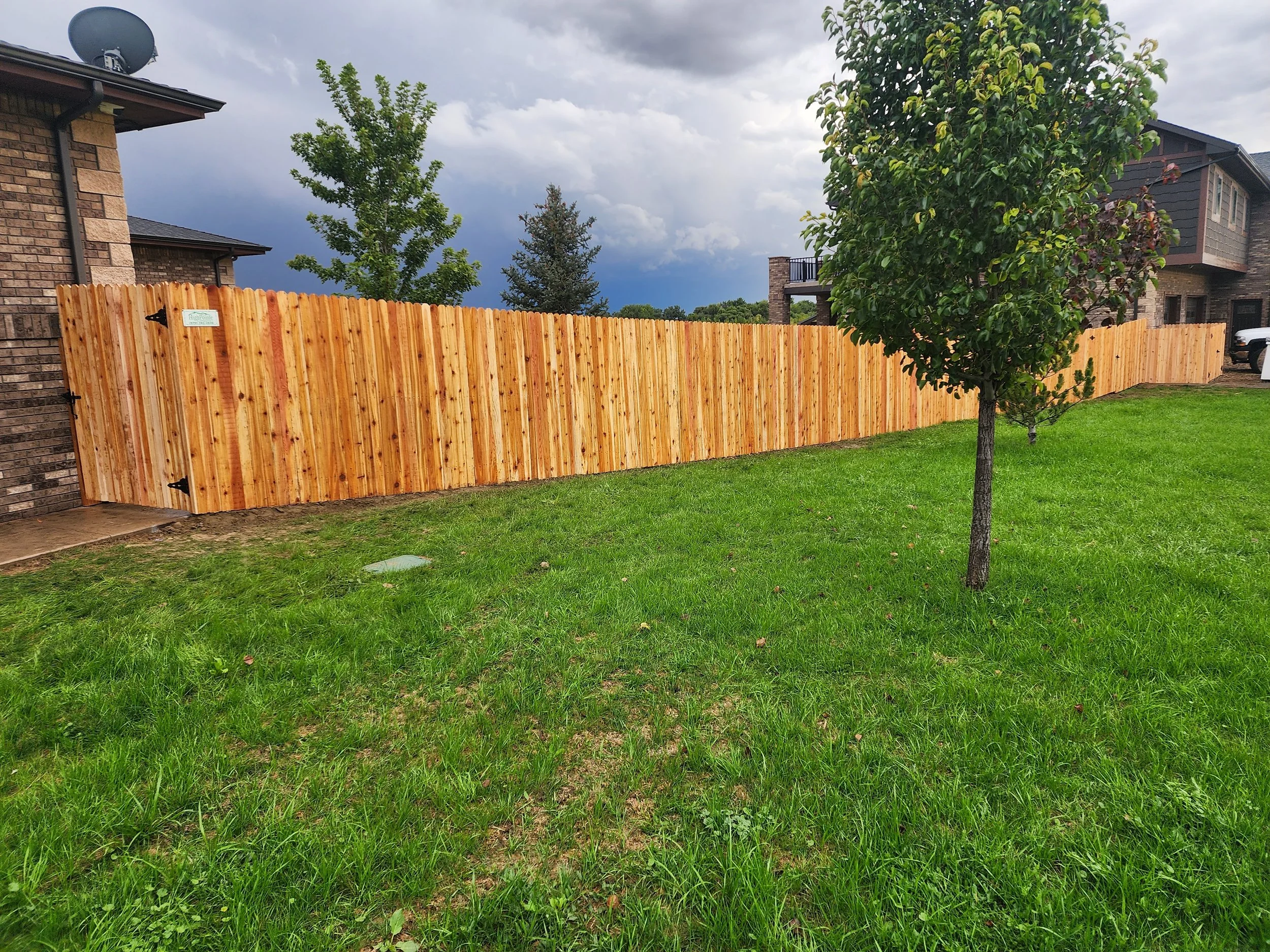 Western red cedar privacy fence installed by High Pointe Companies along a residential property line in Northern Colorado.