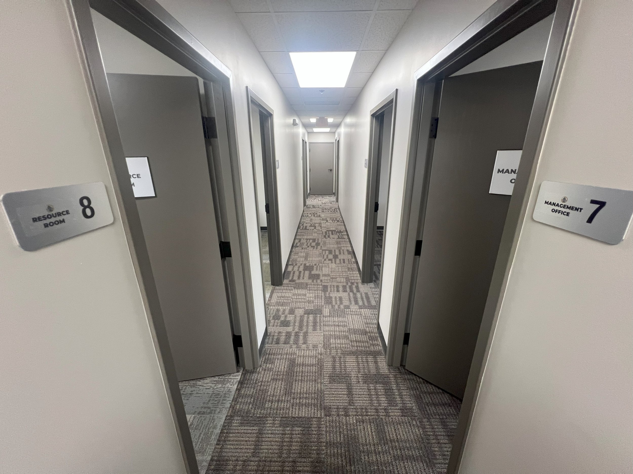 Hospital corridor with doorways labeled resource room 8 and management office 7