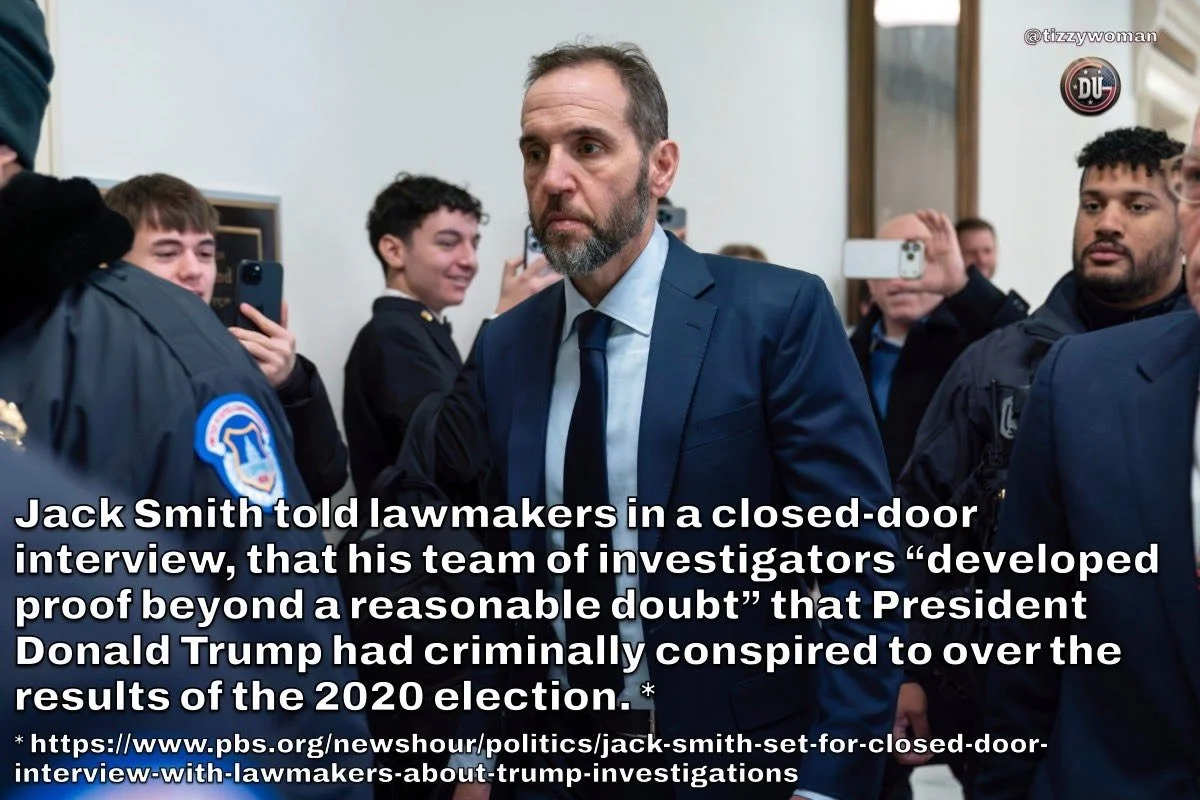 Jack Smith, wearing a blue suit, in a crowded room with people taking photos of him, during a closed-door interview about allegations that President Donald Trump conspired to interfere in the 2020 election.