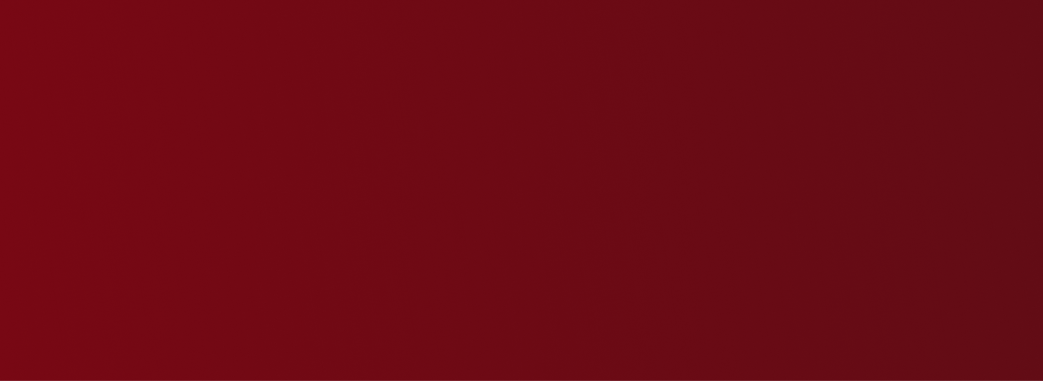 Close-up of a red fabric with a decorative floral embroidery pattern.