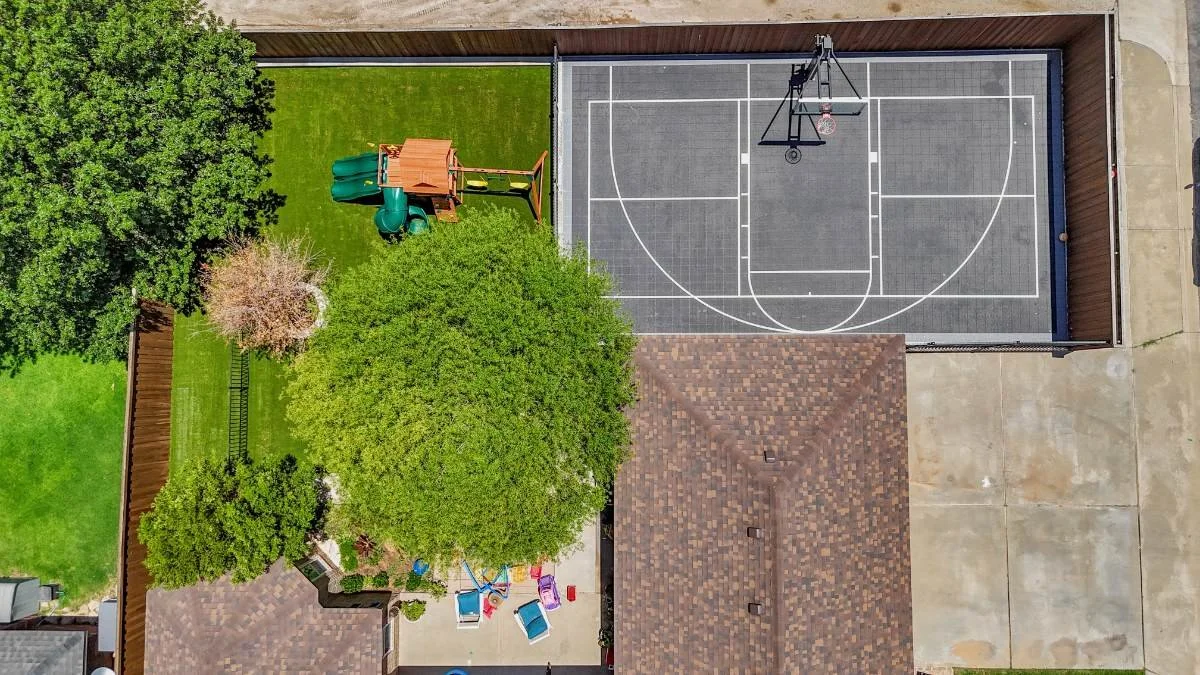 Aerial layout of backyard sports retreat featuring synthetic turf play zone and structured court design in Monahans, TX