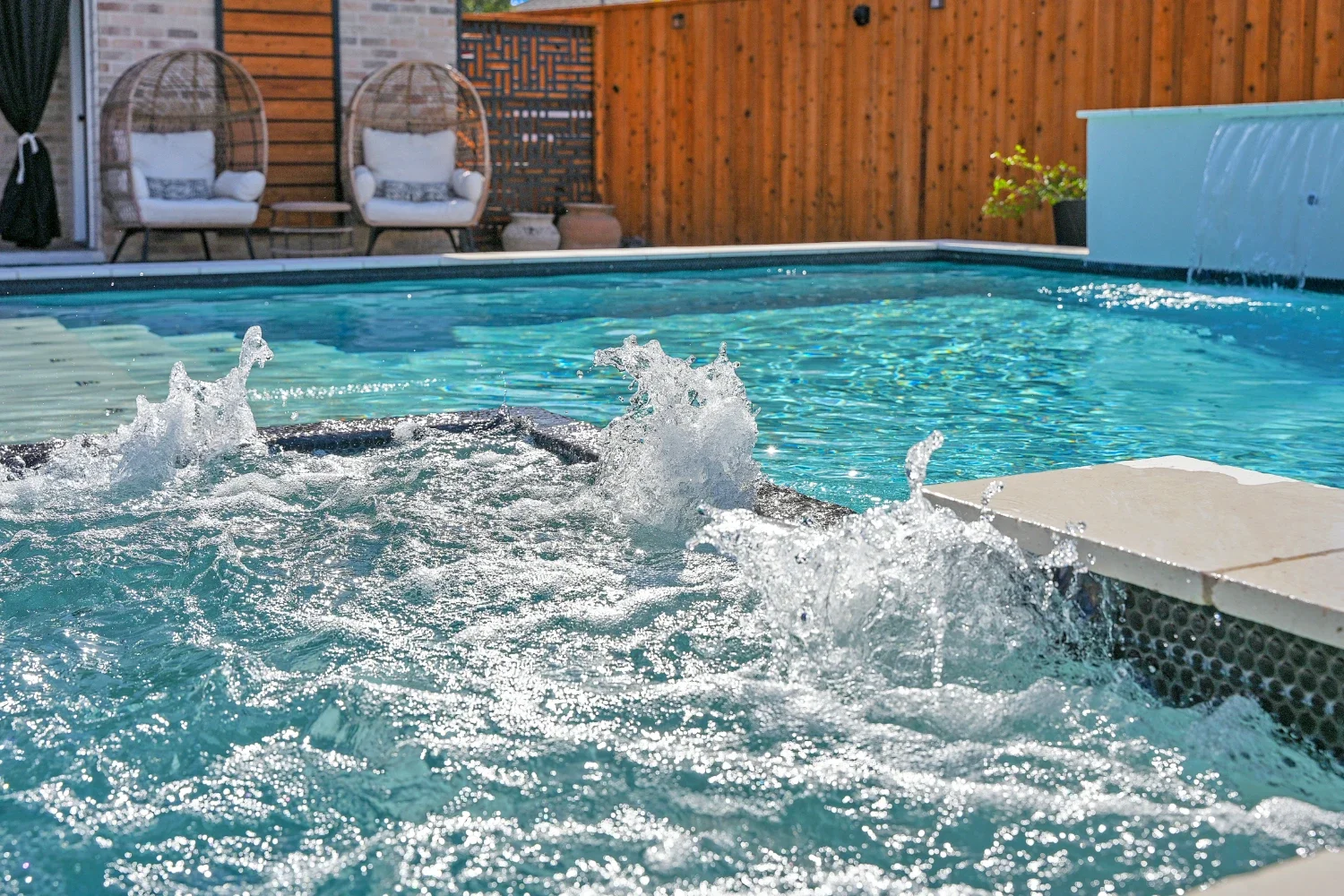 Backyard pool builder near me installing spa features in Monahans, TX