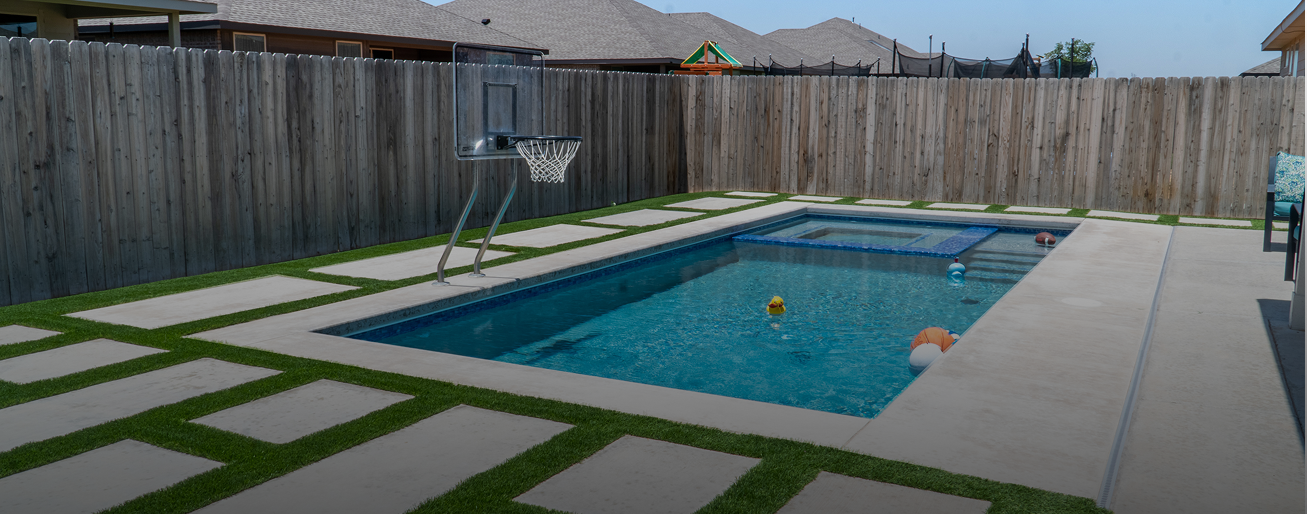 Custom pools & spas with modern patio and clean landscape design in Midland, TX