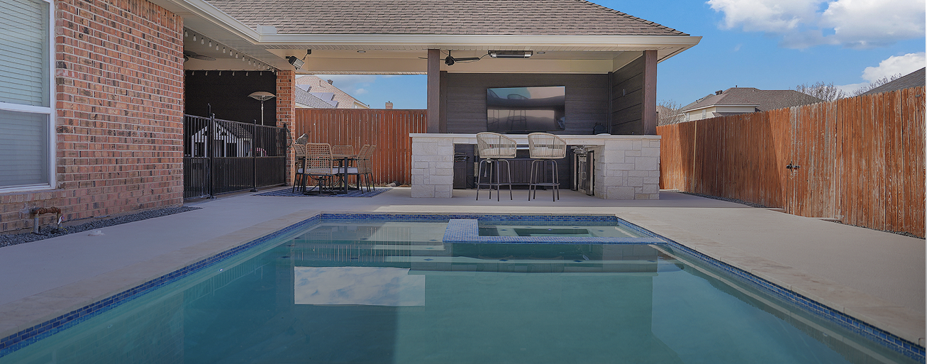 Outdoor kitchen and pool builder near me project with covered patio in Lubbock, TX