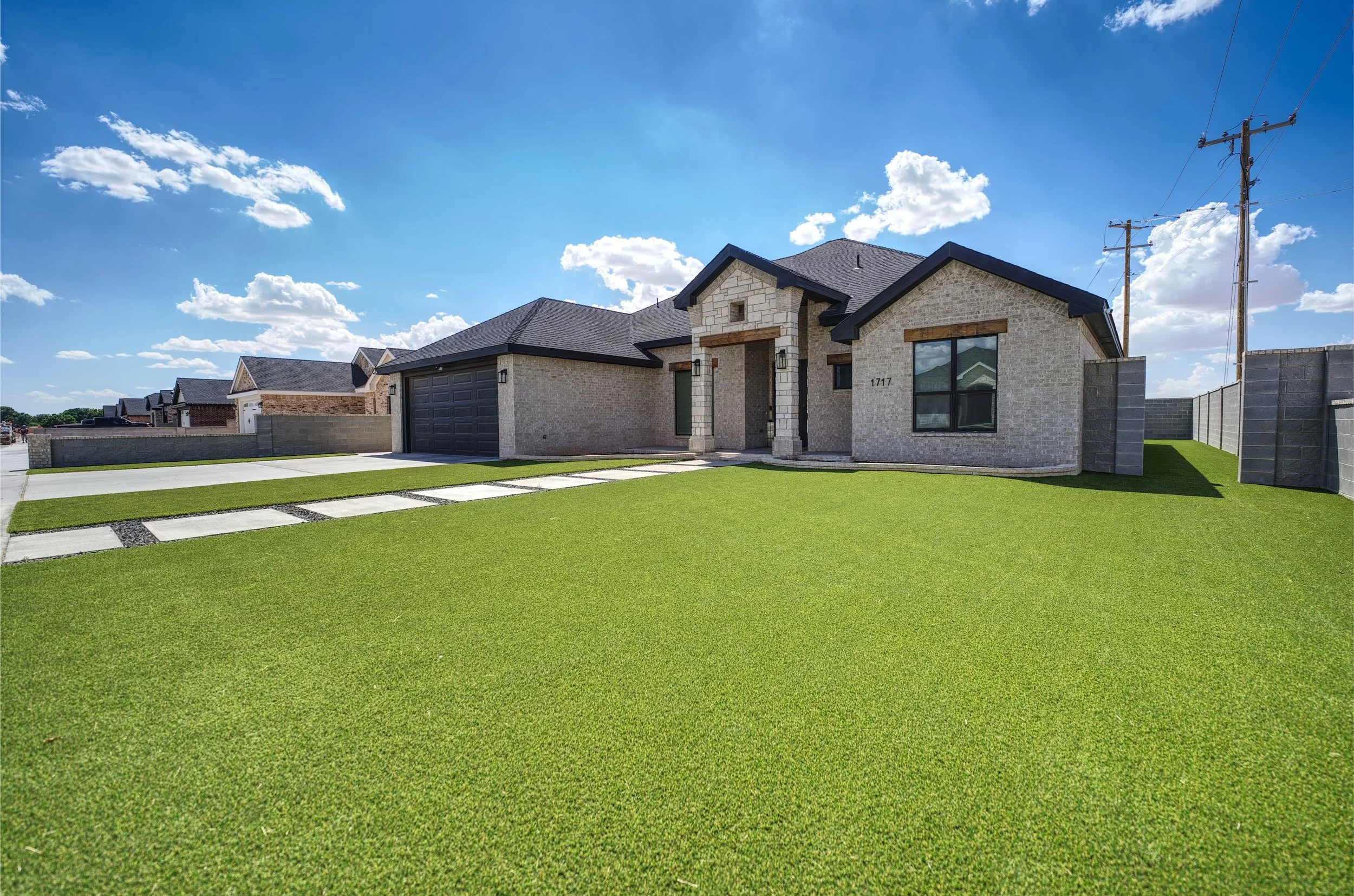 artificial turf lawn installation with clean edging in San Angelo, TX