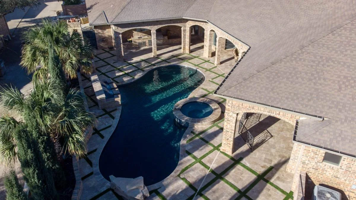 Aerial view of residential pools & spas renovation with integrated artificial turf and hardscape in Lubbock, TX