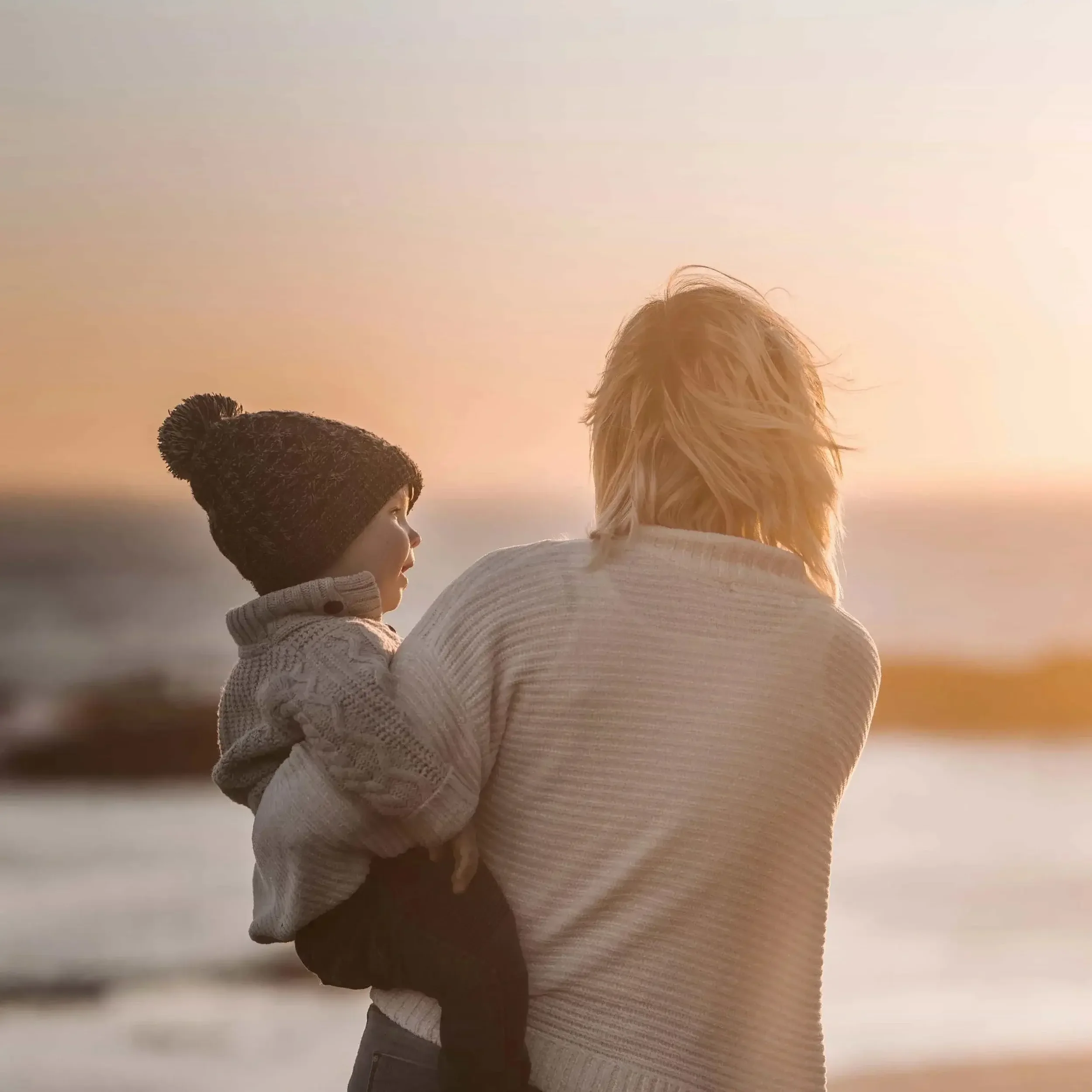 Mom holder her baby at the beach