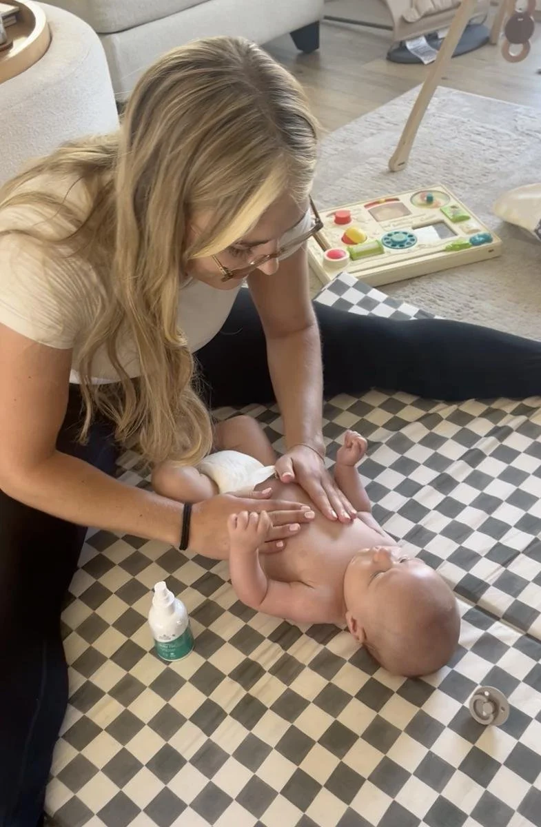 Pediatric physical therapist assessing a baby's trunk and core control during an in-home visit in Costa Mesa, CA.