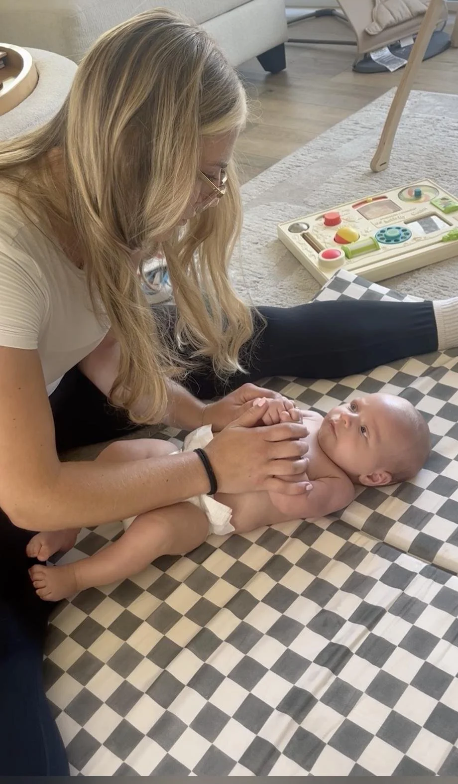 Pediatric physical therapist treating a baby on a floor mat during an in-home visit serving Irvine, CA.