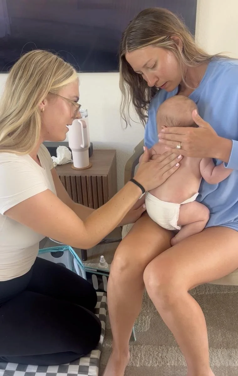 Pediatric physical therapist assessing a baby's head shape with a parent during an in-home plagiocephaly visit in Costa Mesa, CA.