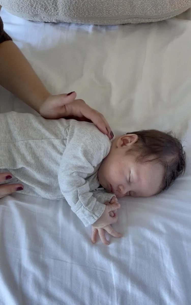 Baby resting with head turned to one side, illustrating the positioning preference often seen with infant torticollis.