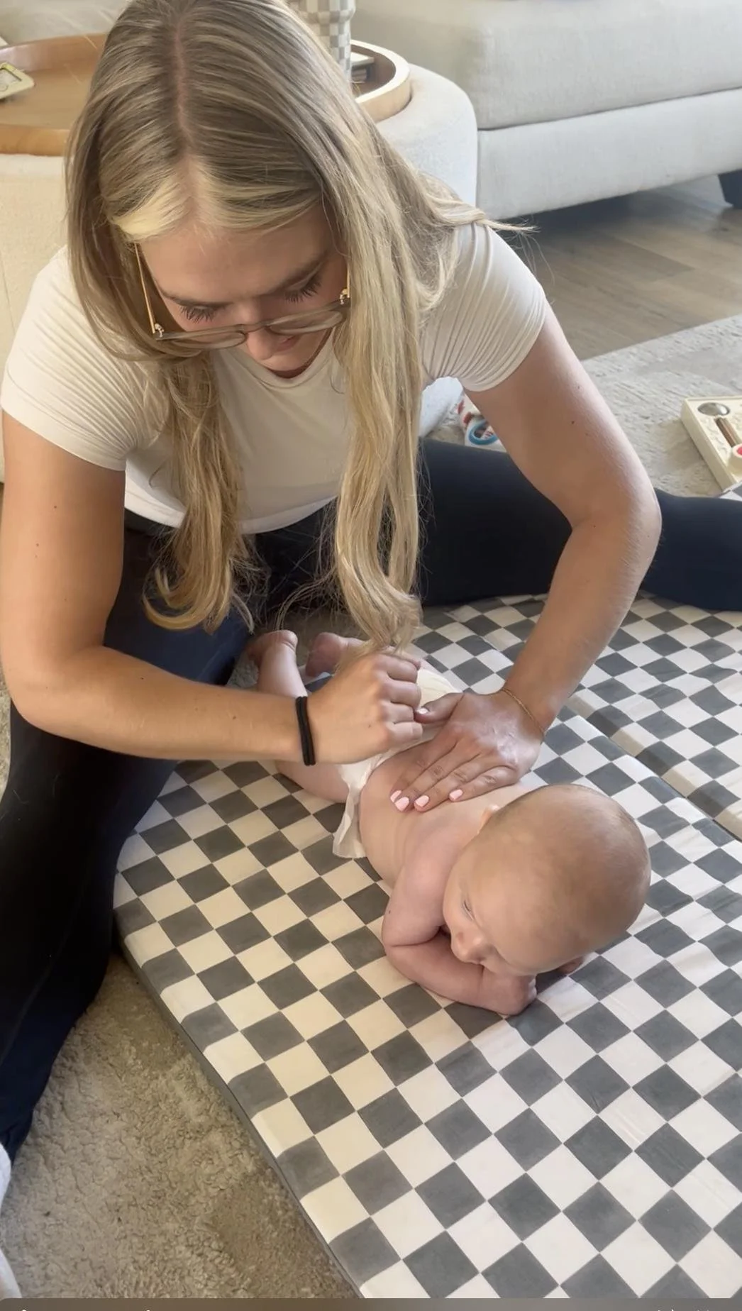 Physical therapist guiding a baby through tummy time to build strength, in-home visit serving Irvine, CA.