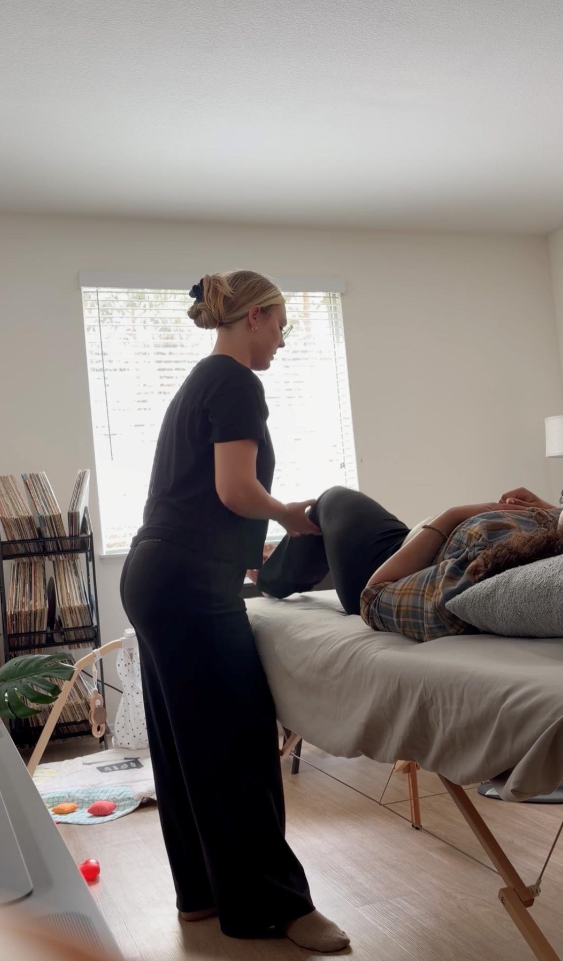 Dr. Avonlea Brown performing hands-on treatment with a patient lying on the table — Avonlea Brown Physical Therapy, Costa Mesa, CA.
