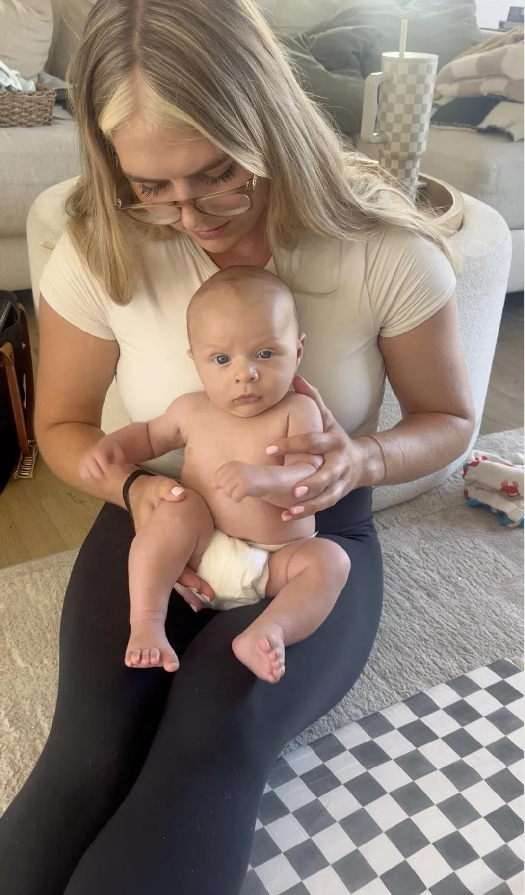 Pediatric physical therapist holding and supporting a baby during an in-home plagiocephaly session in Costa Mesa, CA.