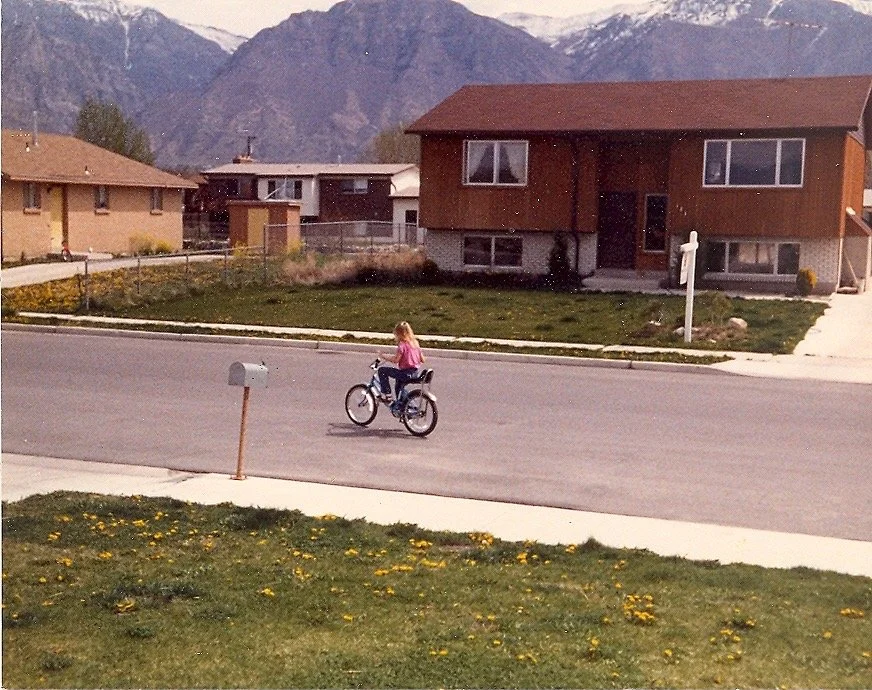 A child riding a bike in an open outdoor space, reflecting freedom, confidence, and a sense of possibility