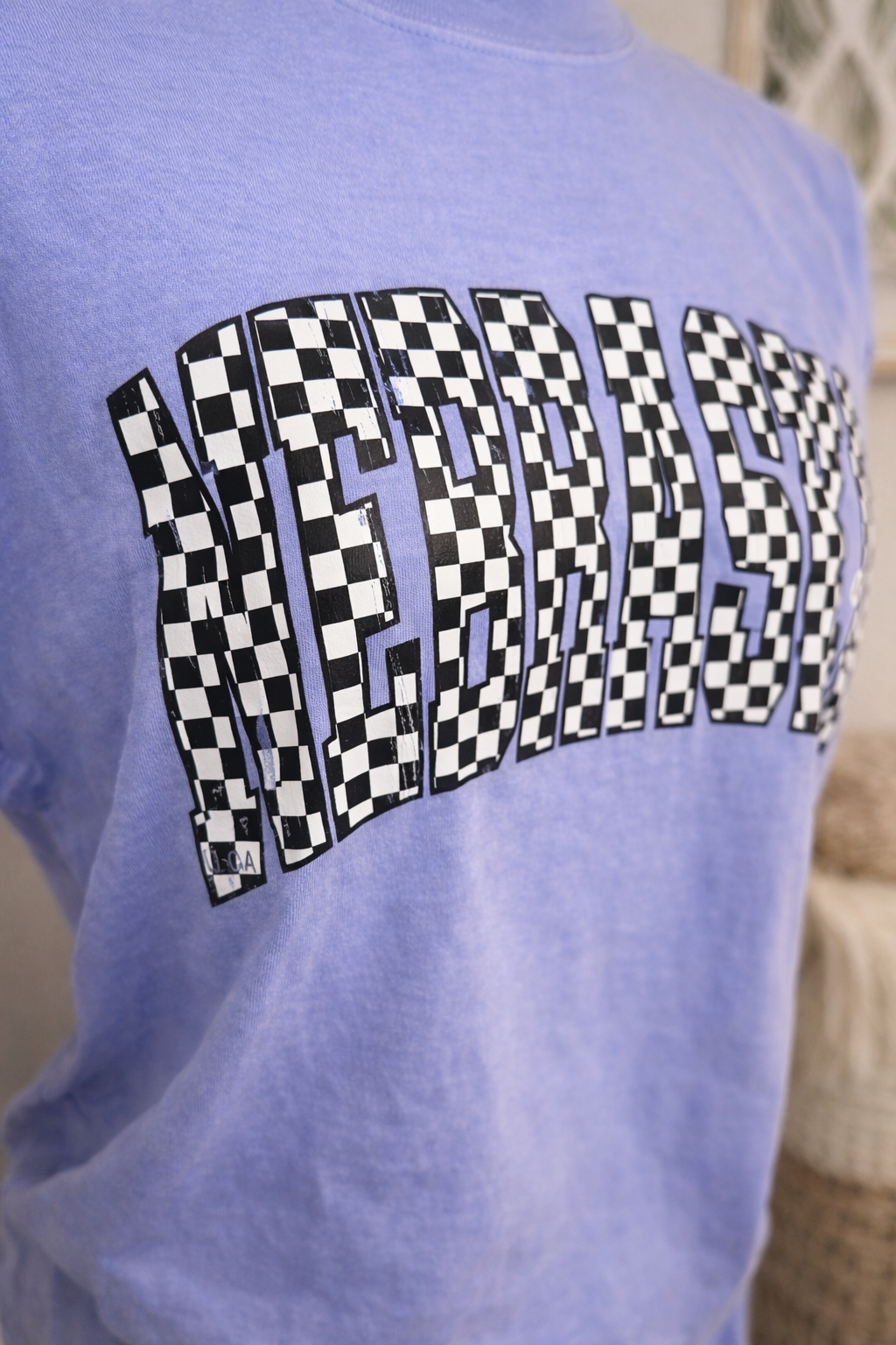 Checkerboard Nebraska shirt close-up.png