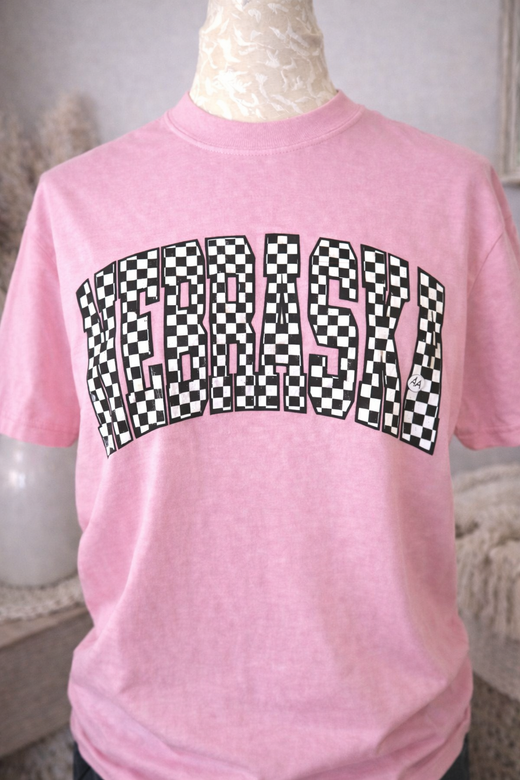 Pink Nebraska T-shirt with checkerboard design.png