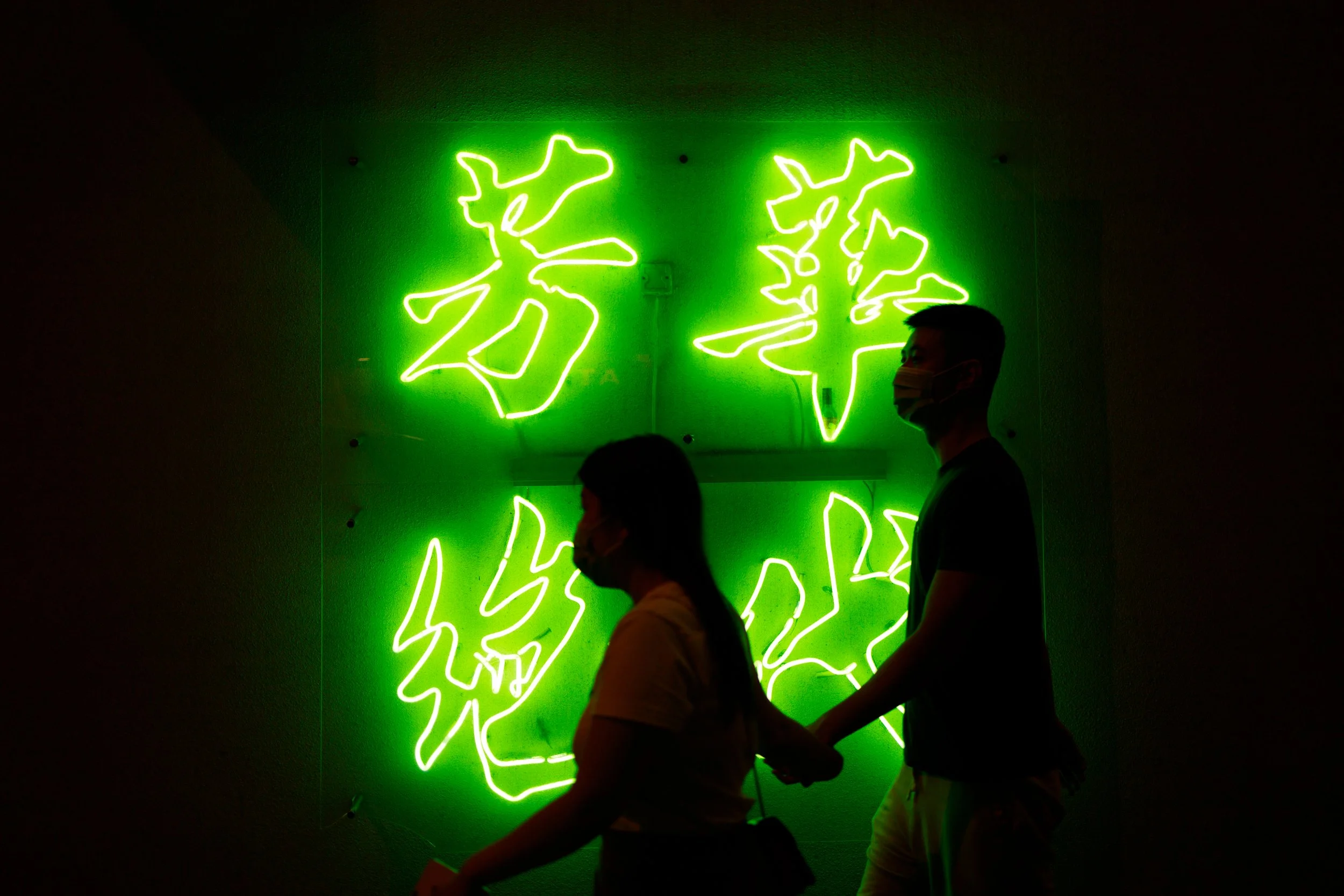 Love & Neon: Shadow of a couple walking in front of an iconic Hong Kong neon display