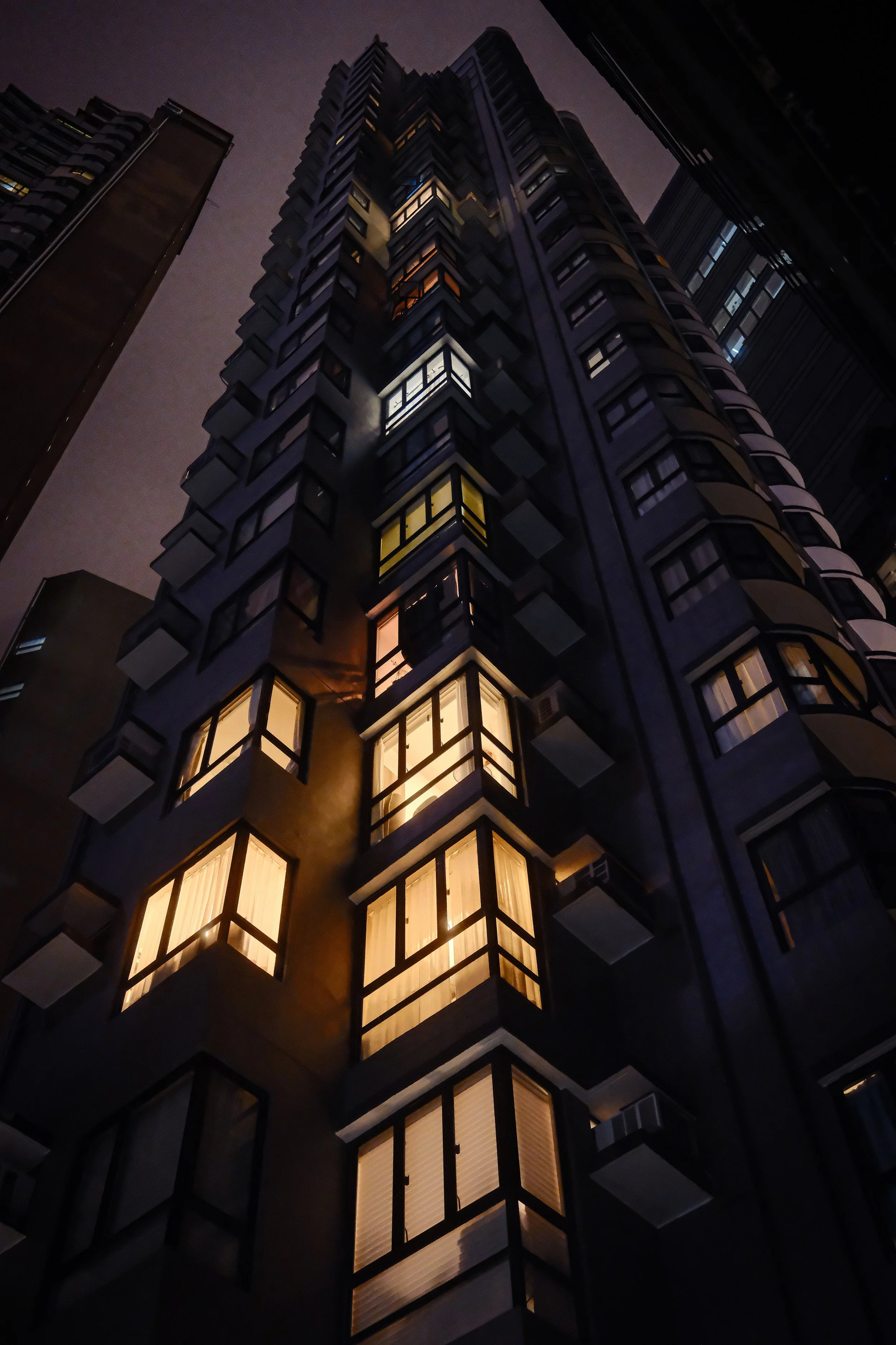 Condensed HousingL A packed Hong Kong skyscrapper at night