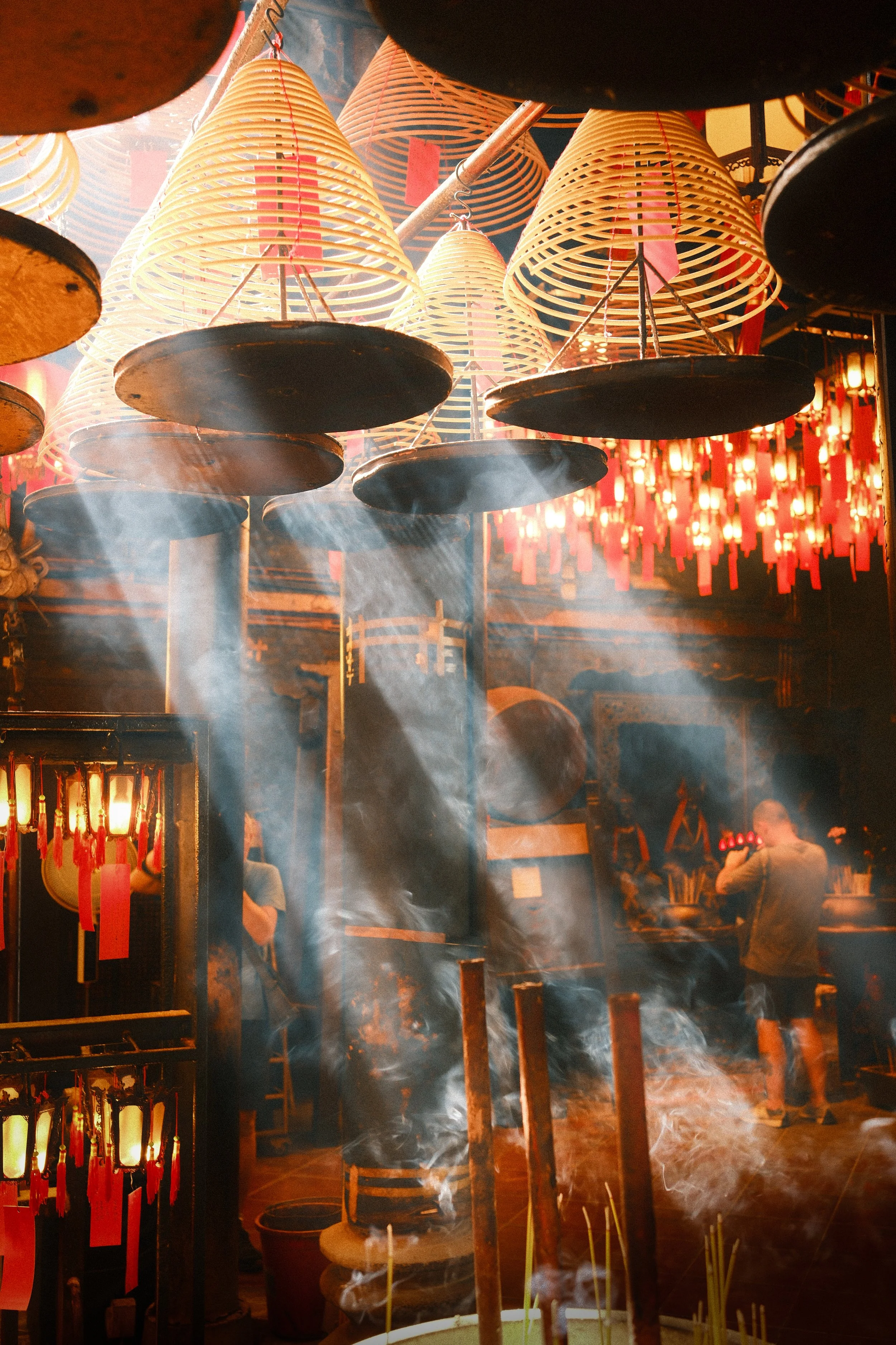 Smoke & Temple: Sunbeams pierce through thick incense smoke in Man Mo Temple, creating an ethereal, sacred ambiance.