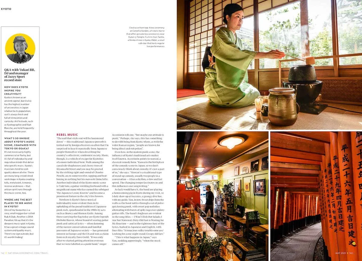 A woman dressed in traditional Japanese clothing performing a tea ceremony inside a room with tatami mats, wooden sliding doors, and paper screens, with the scenery outside visible through the windows.