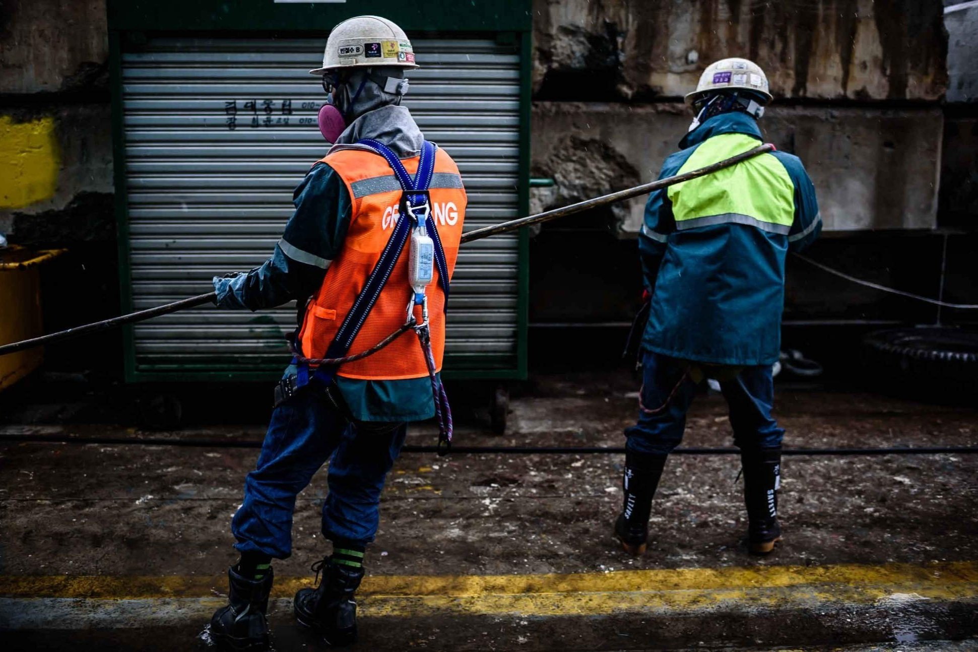 workers-hard-hats-cable-rain.jpg