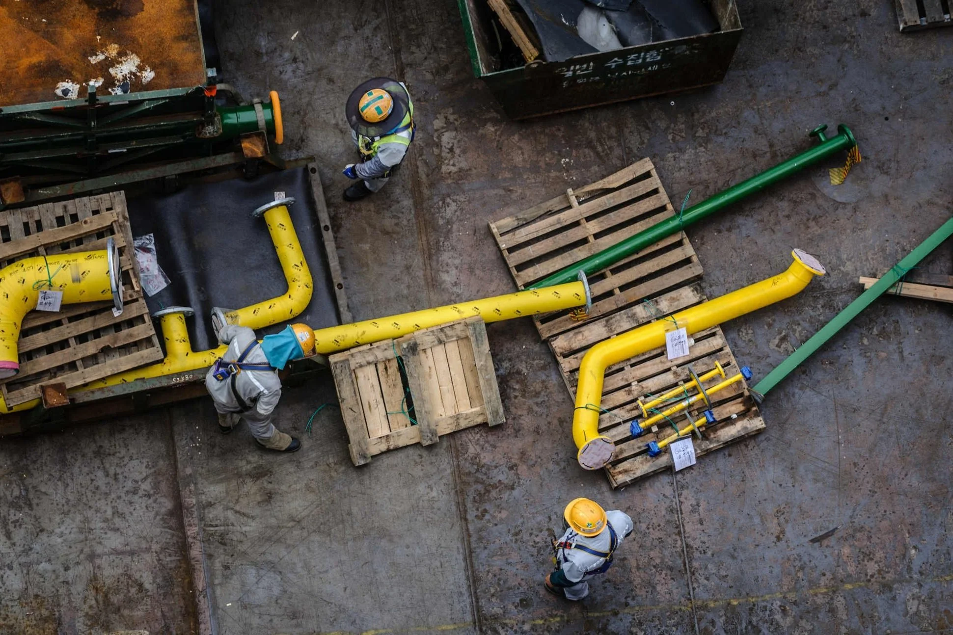 high-angle-industrial-workers-assembling-piping.jpg